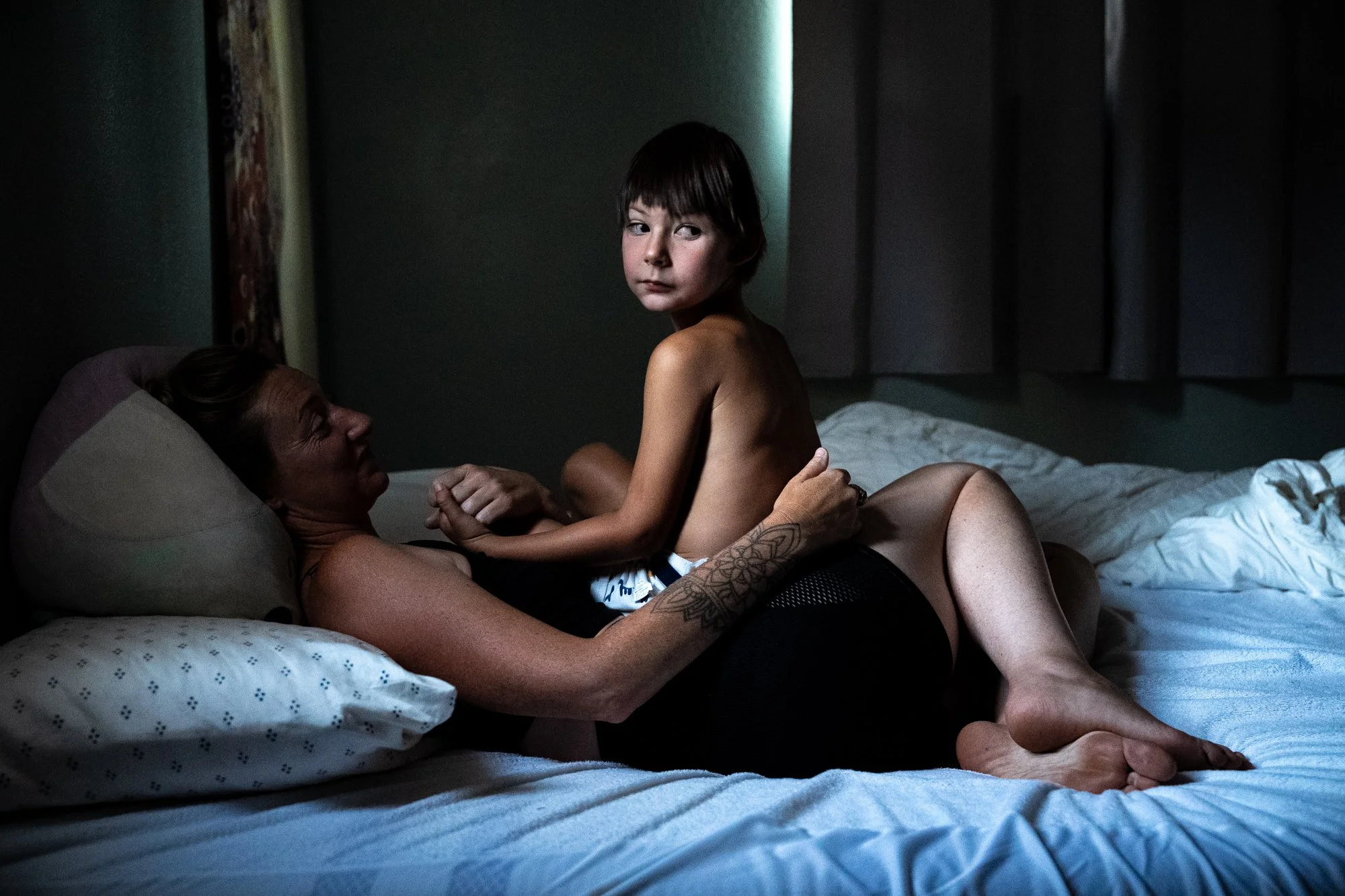 “Mommy loves you, daddy loves you, Ms. Celina loves you, Dani loves you,” Jill McDonald, 46, tells her son, Luca Amine-Hadir, 5, as she helps him settle down for bed on Wednesday, Aug. 20, 2025 at their home in Sebastopol, Calif. Luca lives with epil