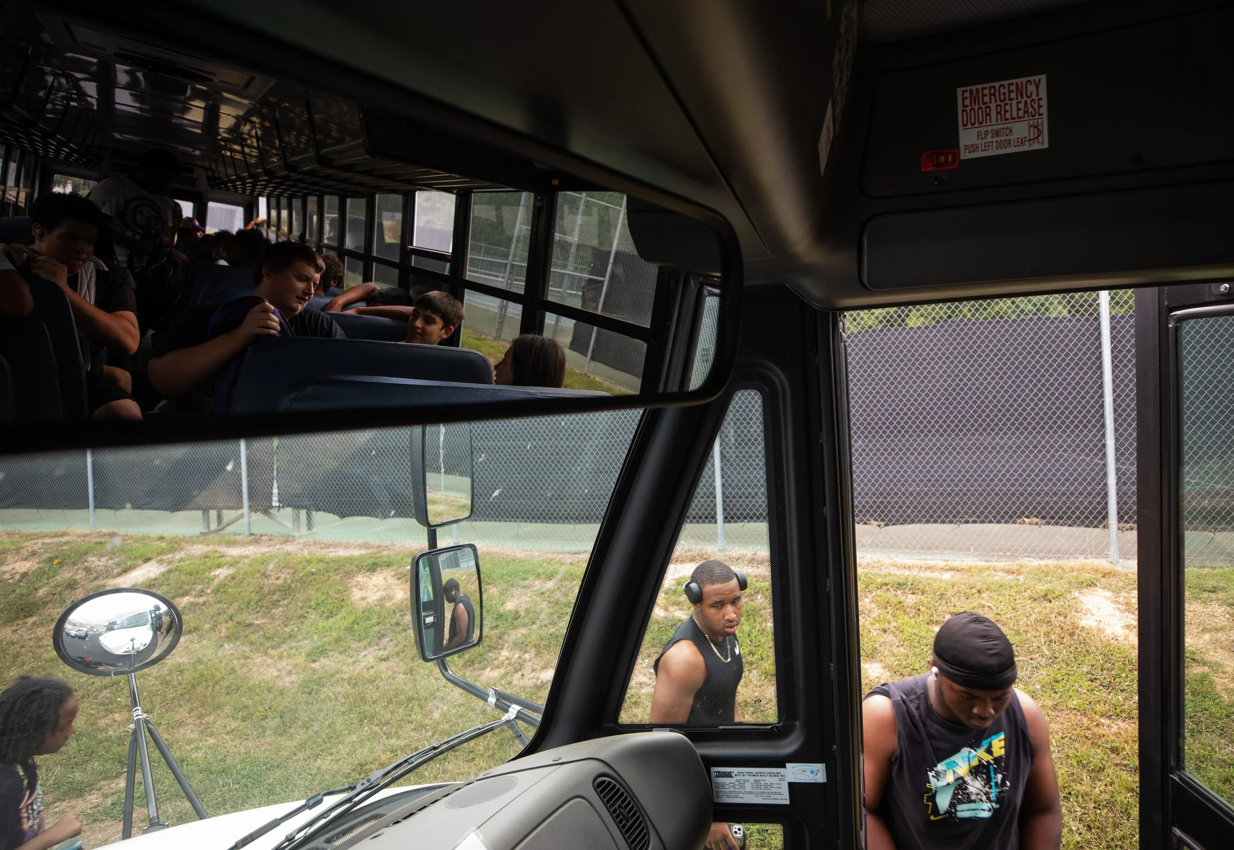 The Riverside High School varsity football team boards the bus to their game against Sanderson on Aug. 25, 2023 in Durham, N.C.