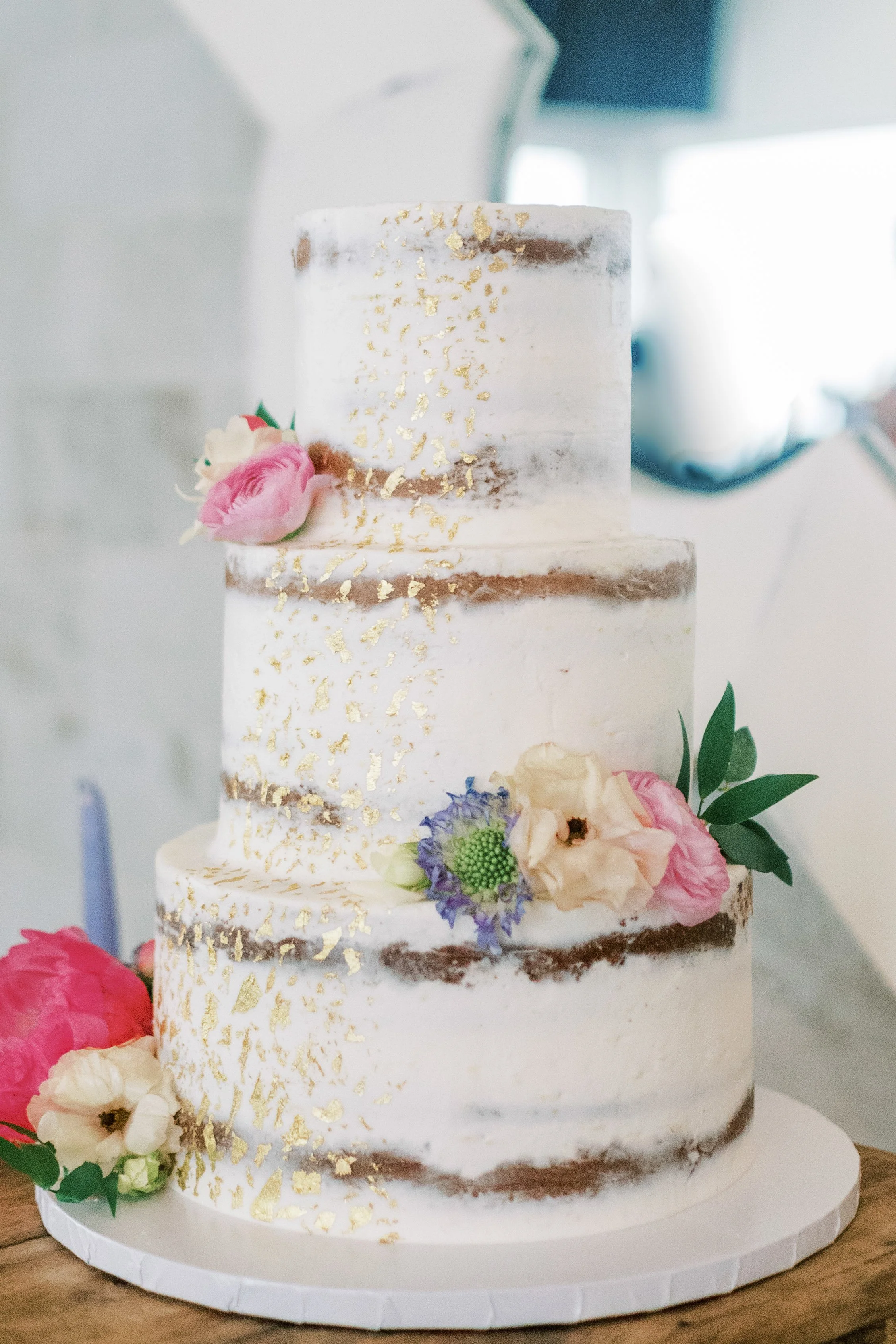 Semi naked wedding cake with gold flake