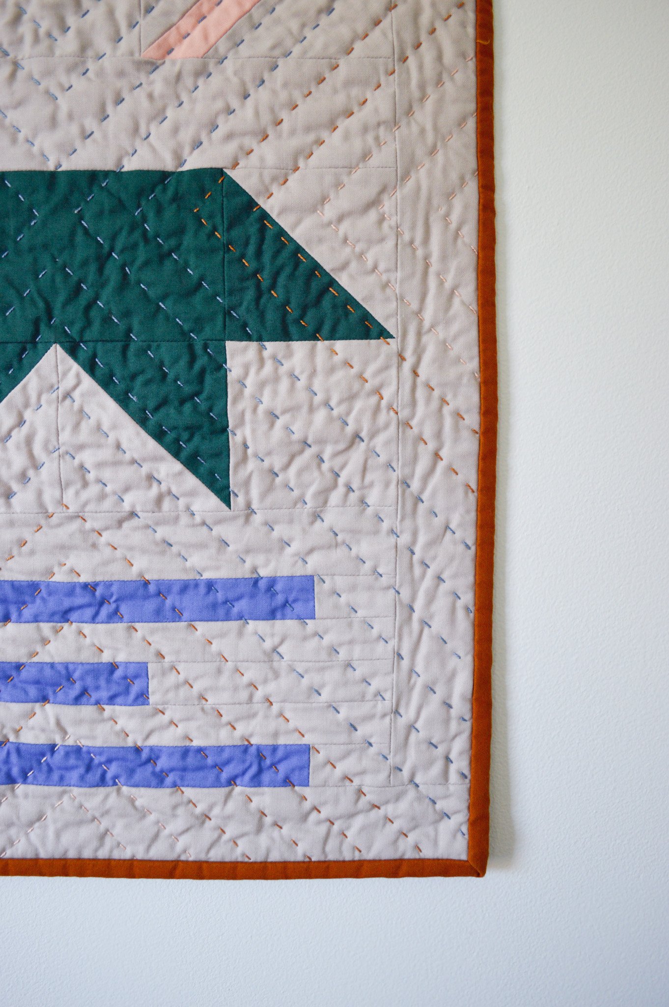  detail of hand stitching on a modern mini quilt 