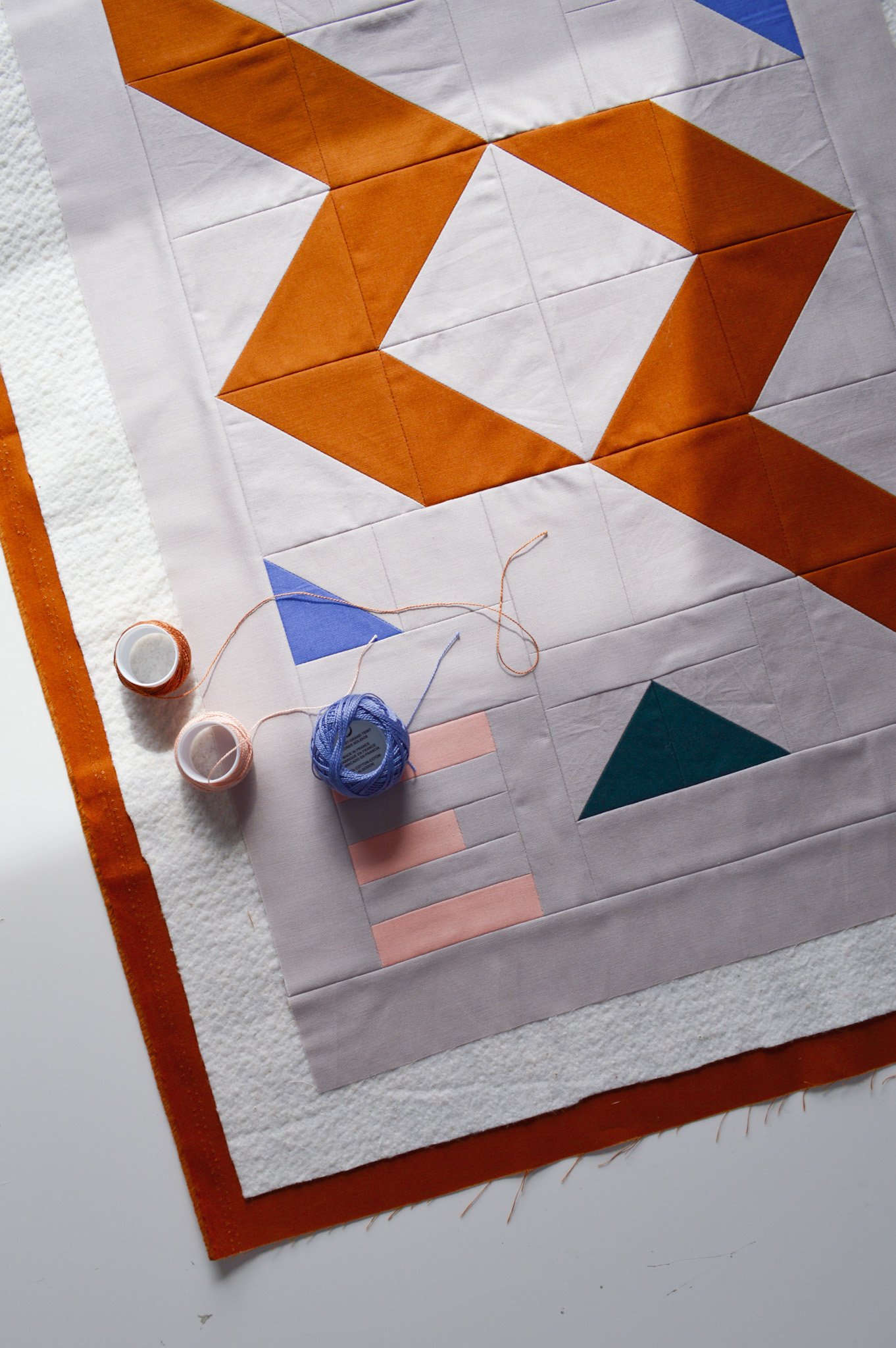  a modern mini quilt, basted, ready to be quilted with colorful quilting thread 