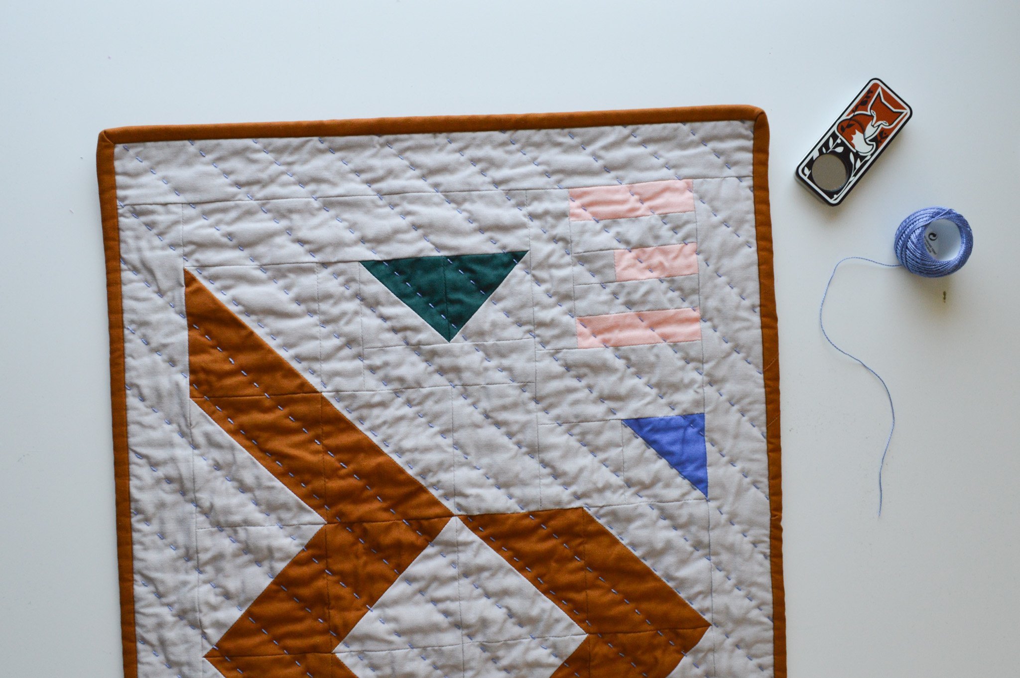  detail of hand stitching on a modern mini quilt 