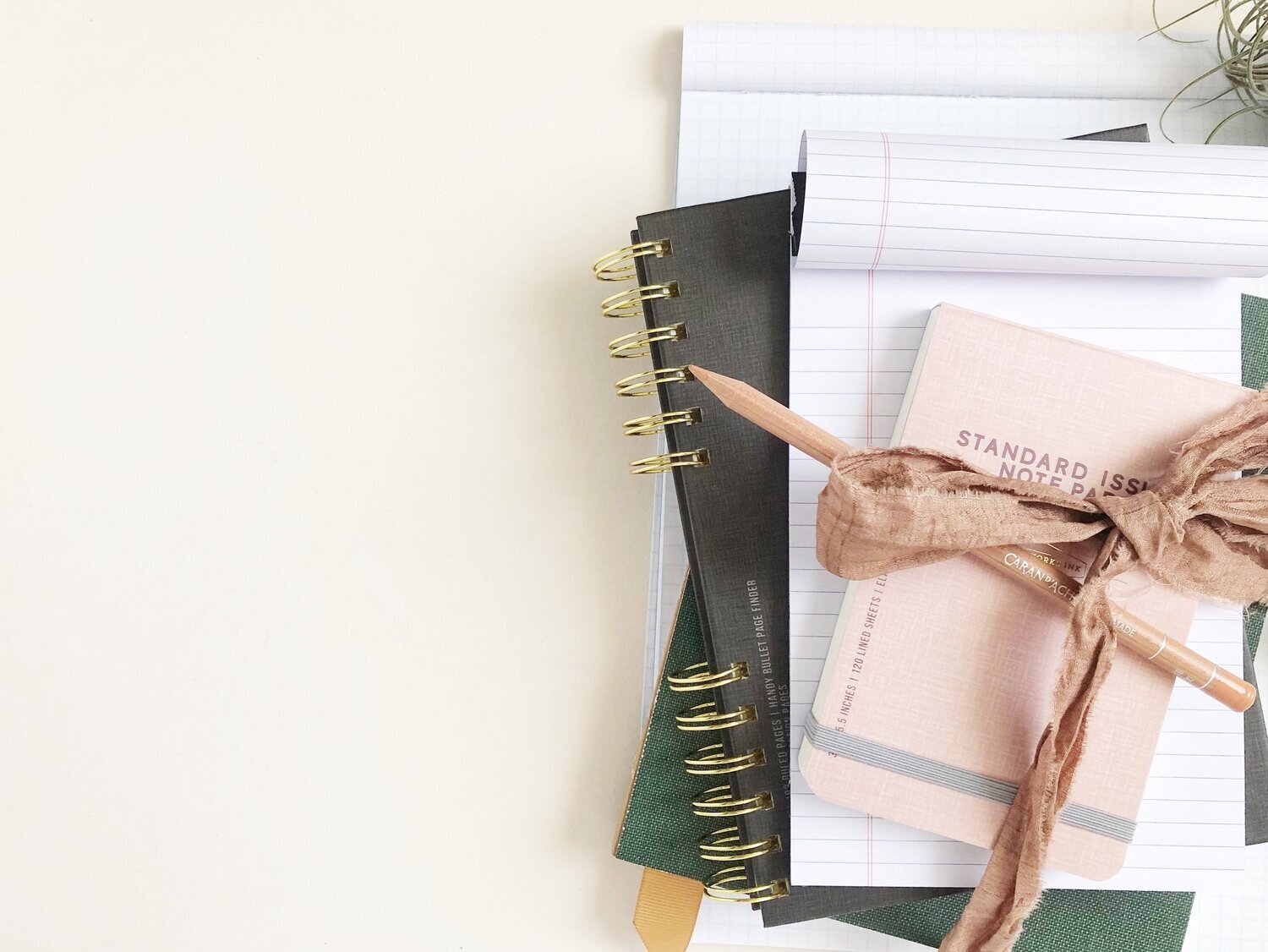Notebooks and notepad on a desk. Get a chance to get free web design, brand, and copywriting feedback from Desk & Design on Mini Audit Mondays