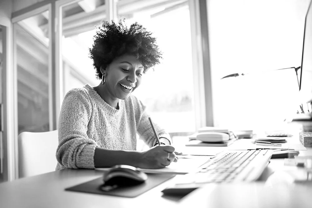 Woman sitting at a desk smiling