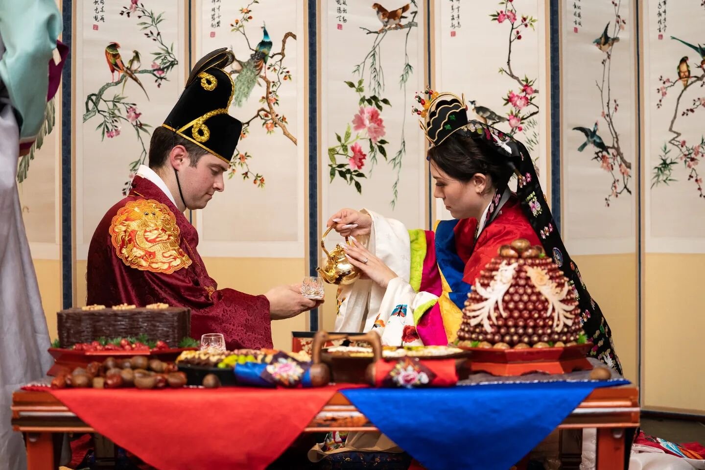 Julia and Copeland had two beautiful nights of wedding celebrations! Night one was the Paebaek ceremony, a Korean wedding tradition to pay respects to their families with a tea ceremony.

One part of the night had family throwing chestnuts and dates 