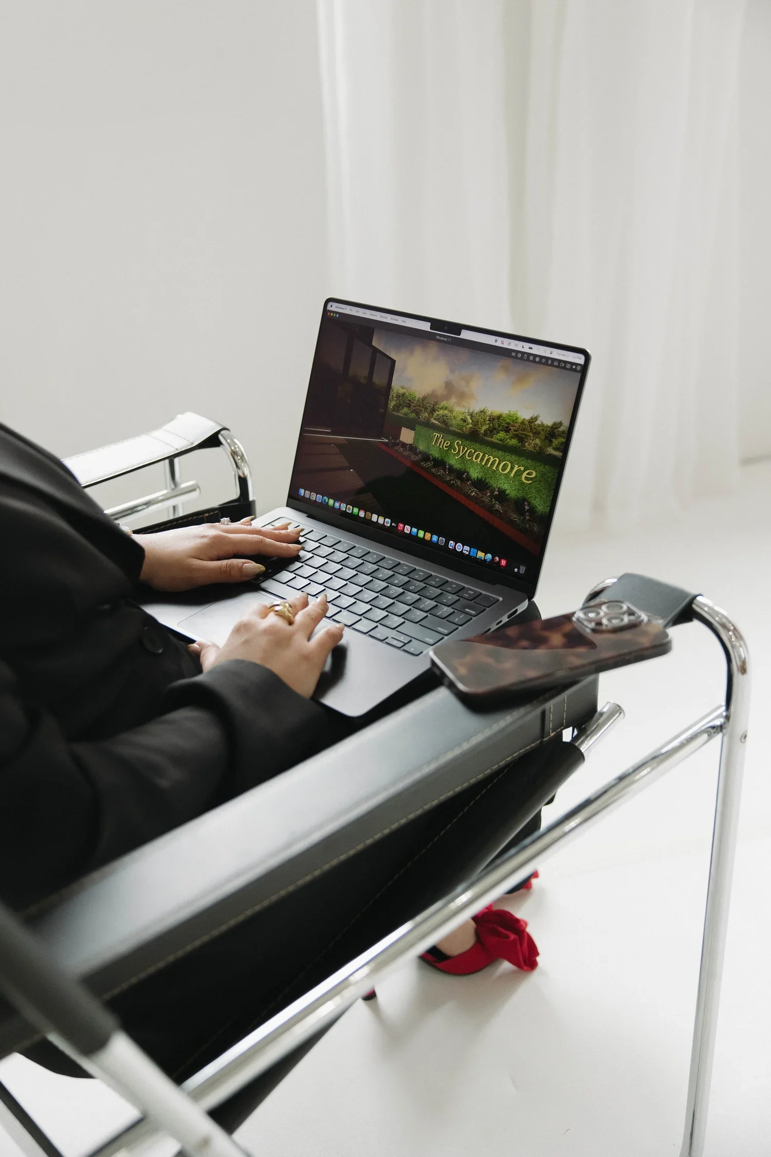 Professional 3D landscape design rendering on a laptop showing a custom backyard project for a client.