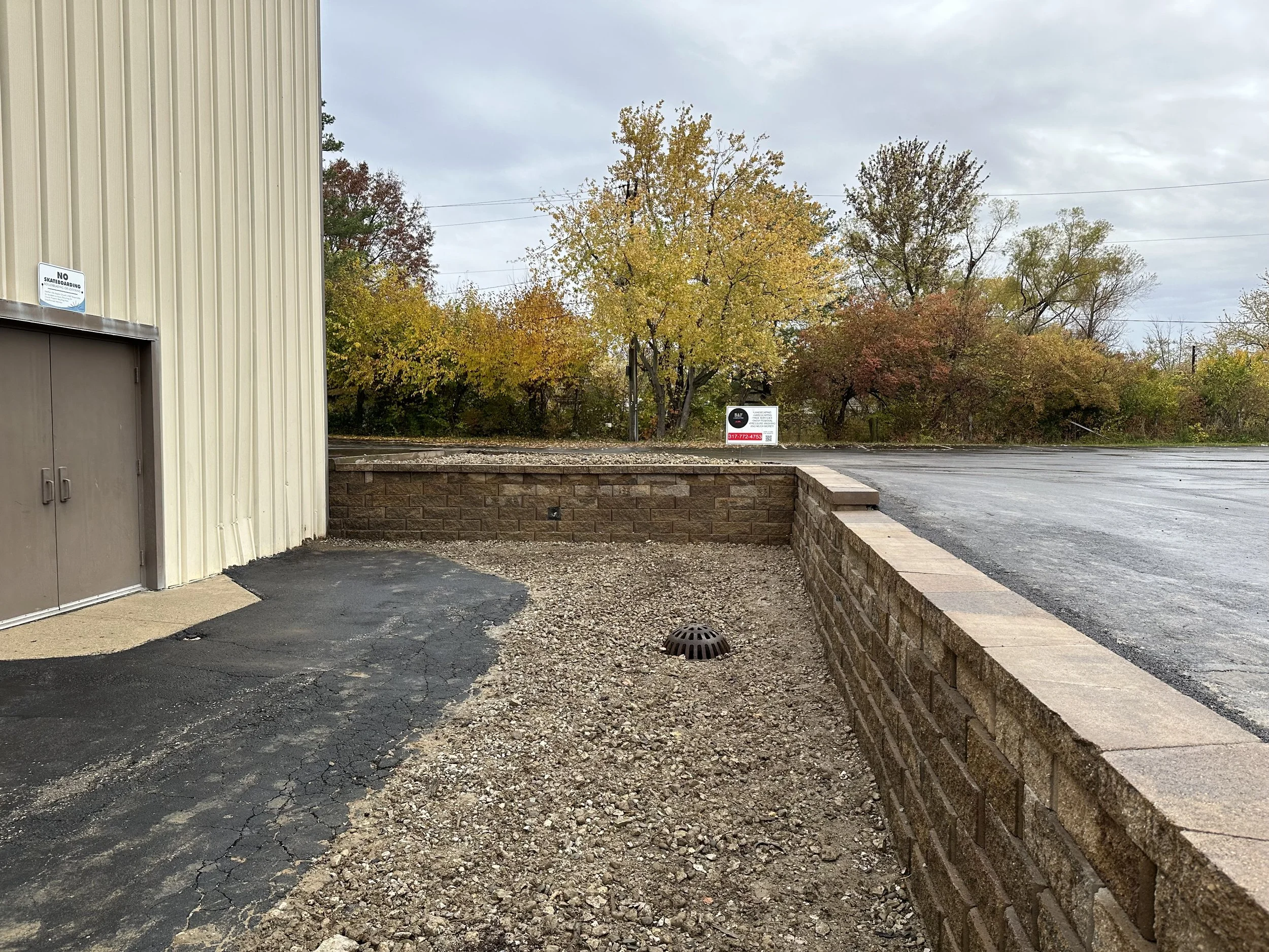 Commercial retaining wall installation with drainage system, completed by B&F Landscaping in Indianapolis.