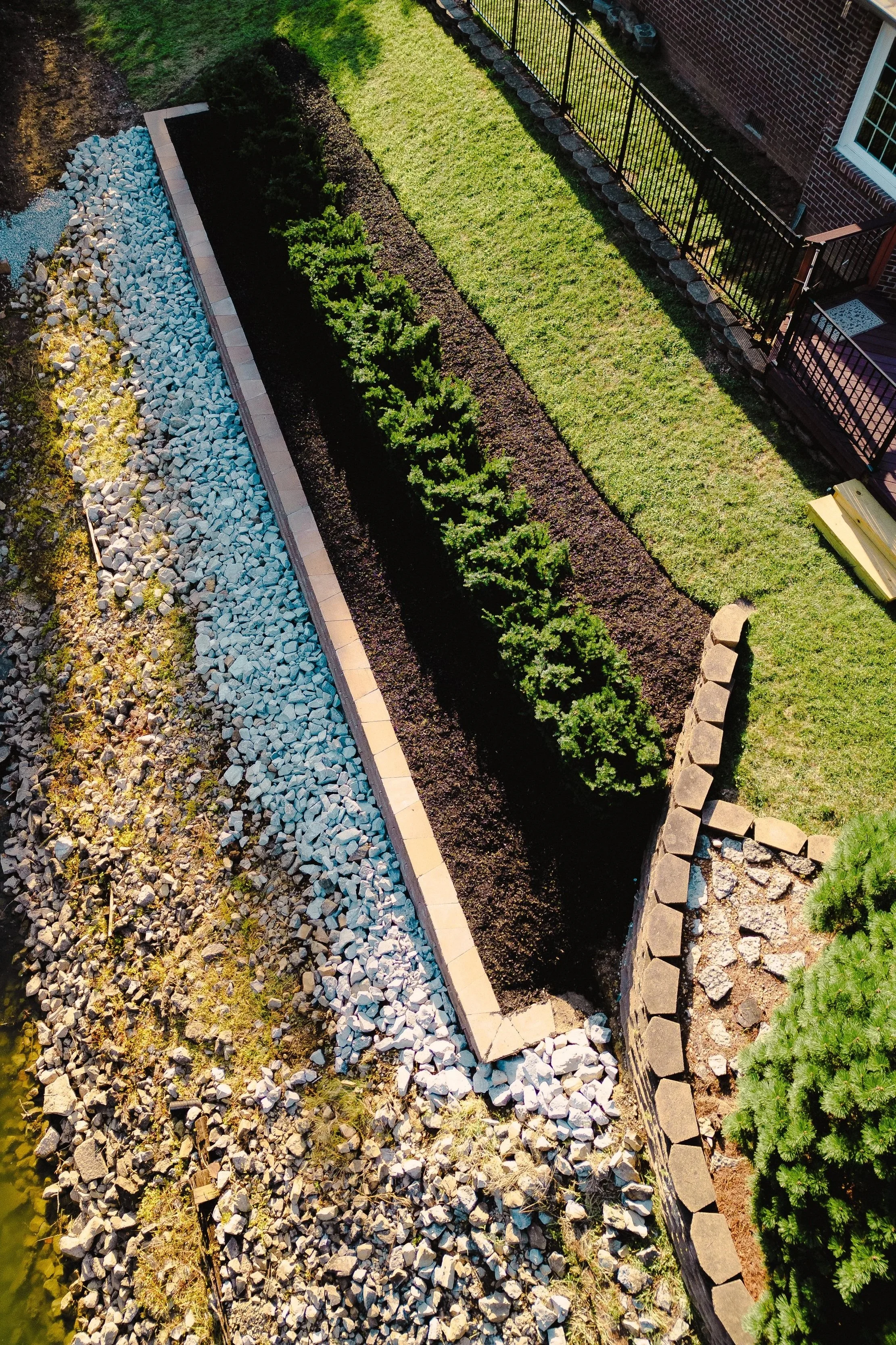Custom retaining wall and waterfront landscaping project featuring stone stabilization, installed by B&F Landscaping in Indianapolis