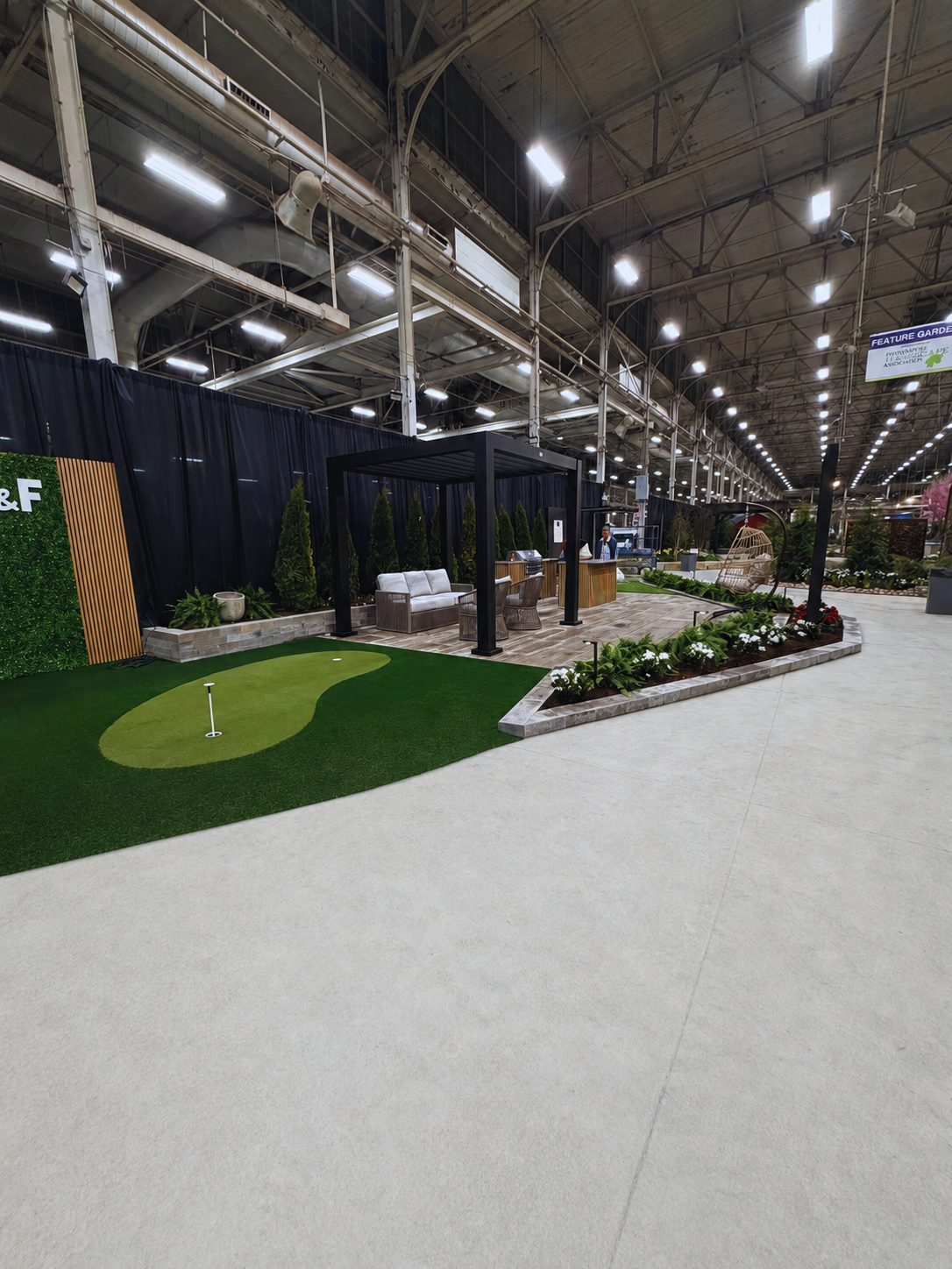 Custom backyard putting green and synthetic turf installation by a professional landscaping service in Indianapolis.
