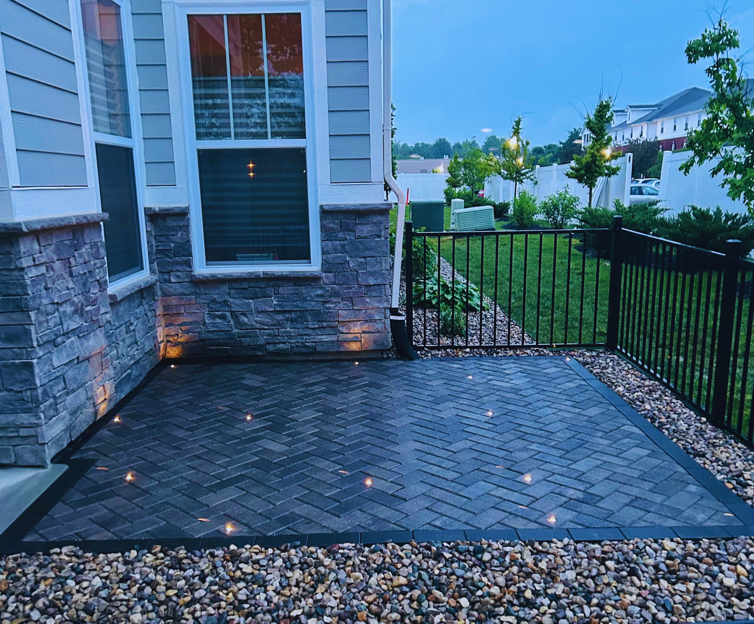 Custom paver patio with herringbone pattern and integrated LED lighting, professionally installed by B&F Landscaping in Indianapolis