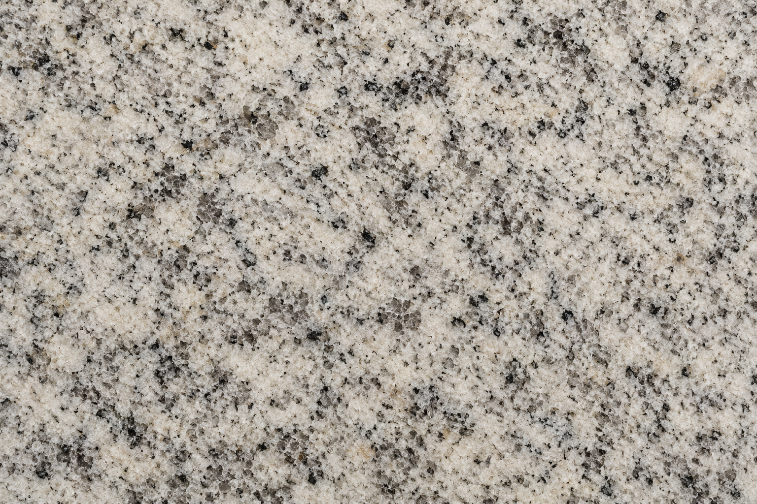 Close-up texture of natural granite countertop used in outdoor kitchen construction.