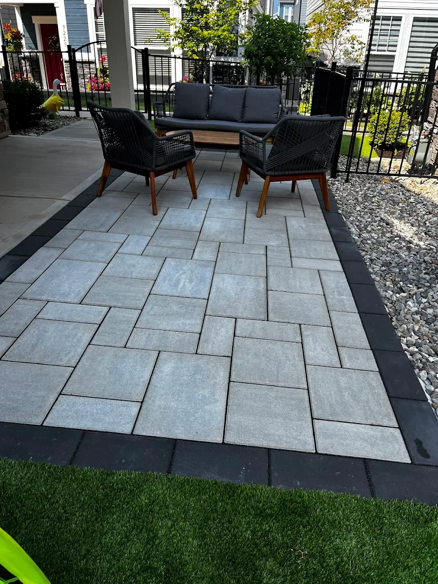 Completed modern backyard patio renovation featuring pavers, artificial turf, and outdoor seating by B&F Landscaping in Indianapolis.