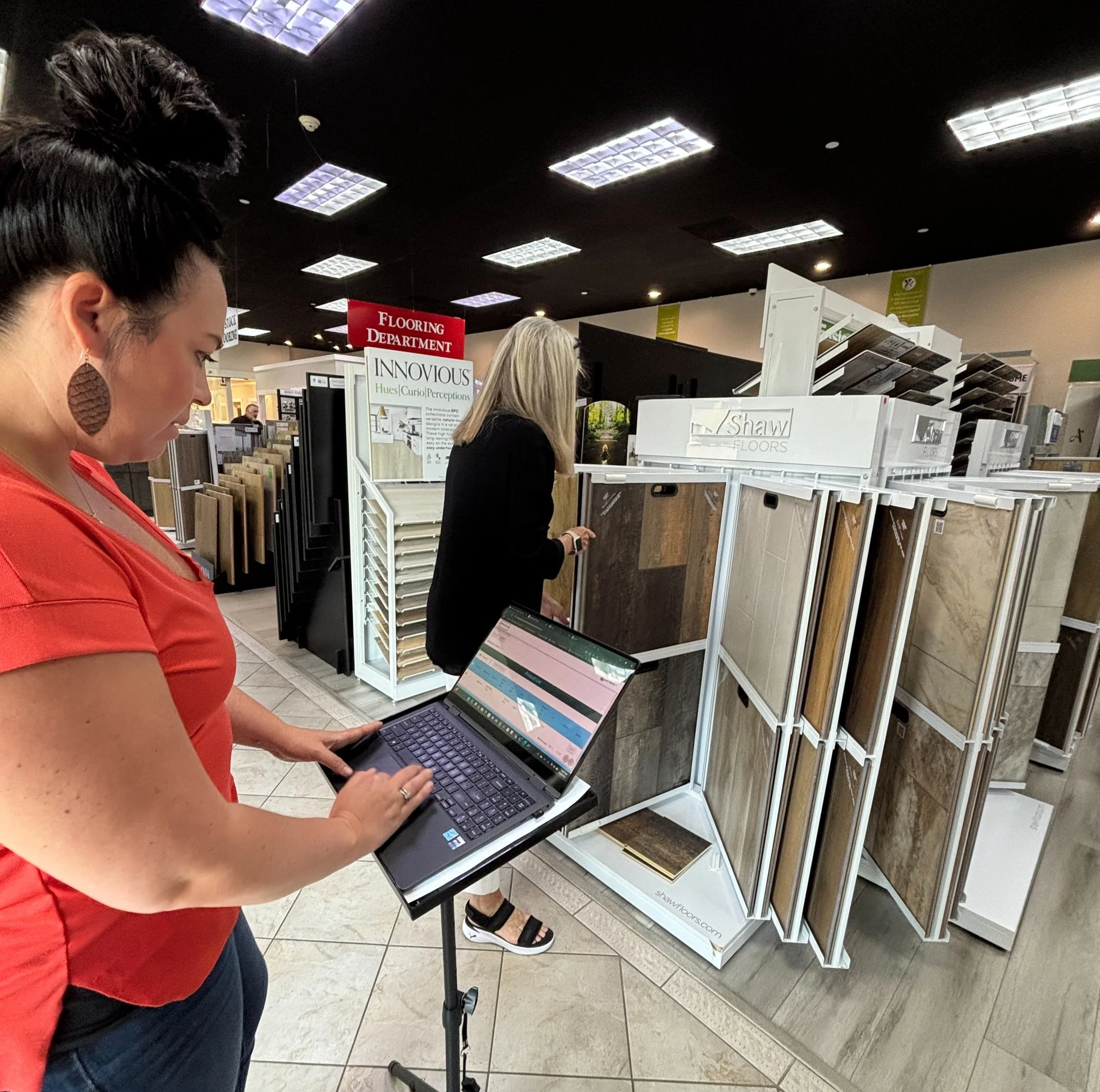 Flooring sales associate using QR code system to access product pricing and details in a showroom
