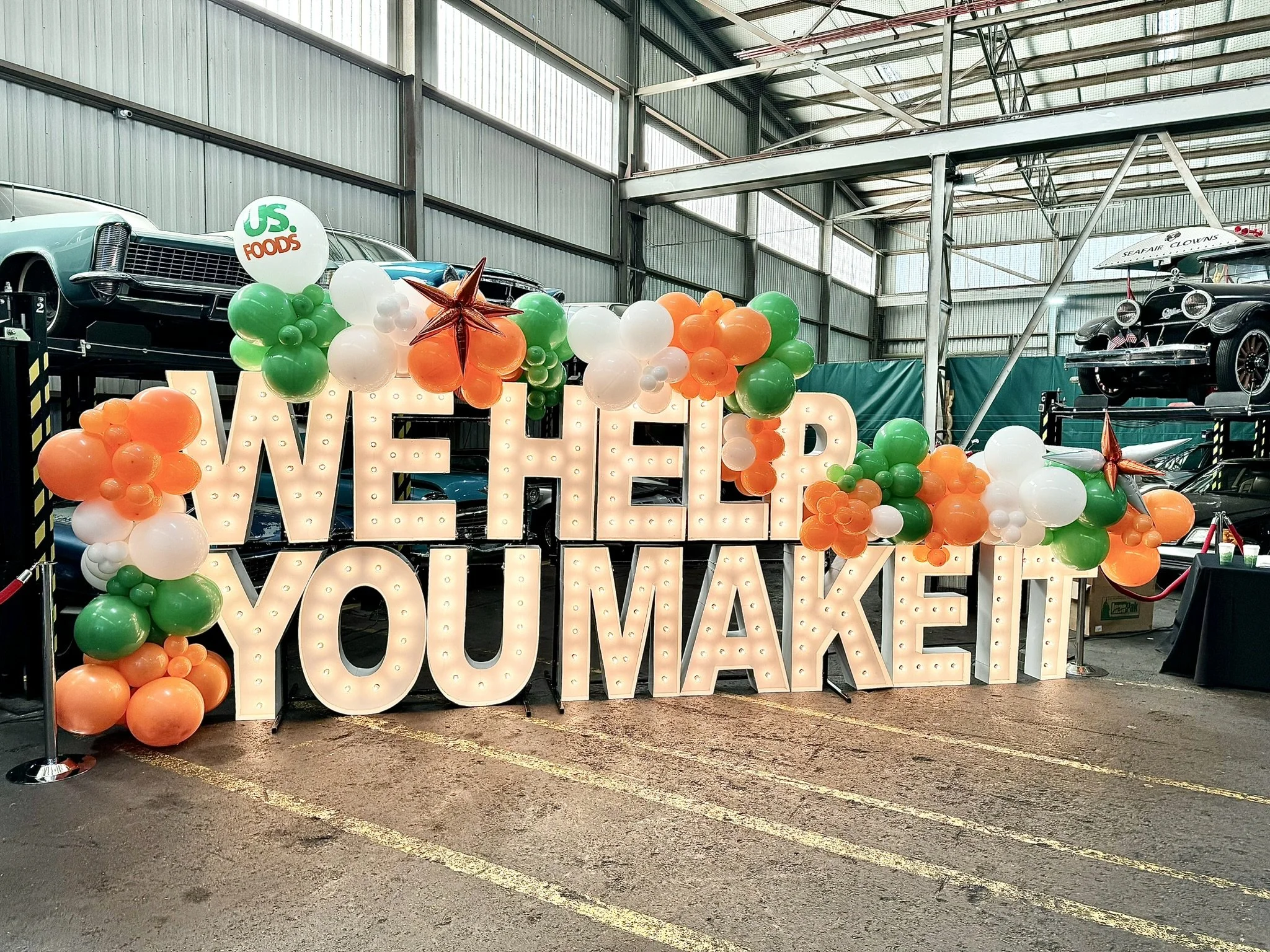 Corporate-event-decoration-services-balloon-decor-giant-letters-US-Foods-orange-green.JPEG