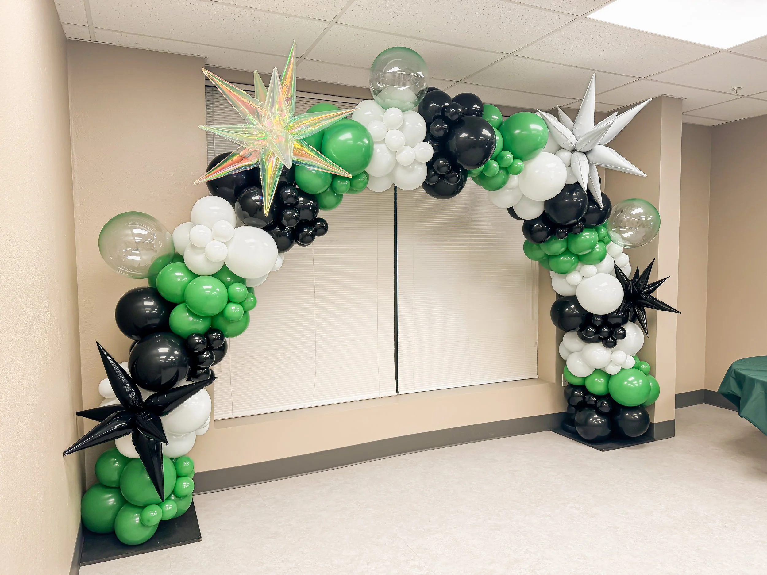 custom-balloon-arch-puyallup-green-white-black-starburst.jpeg