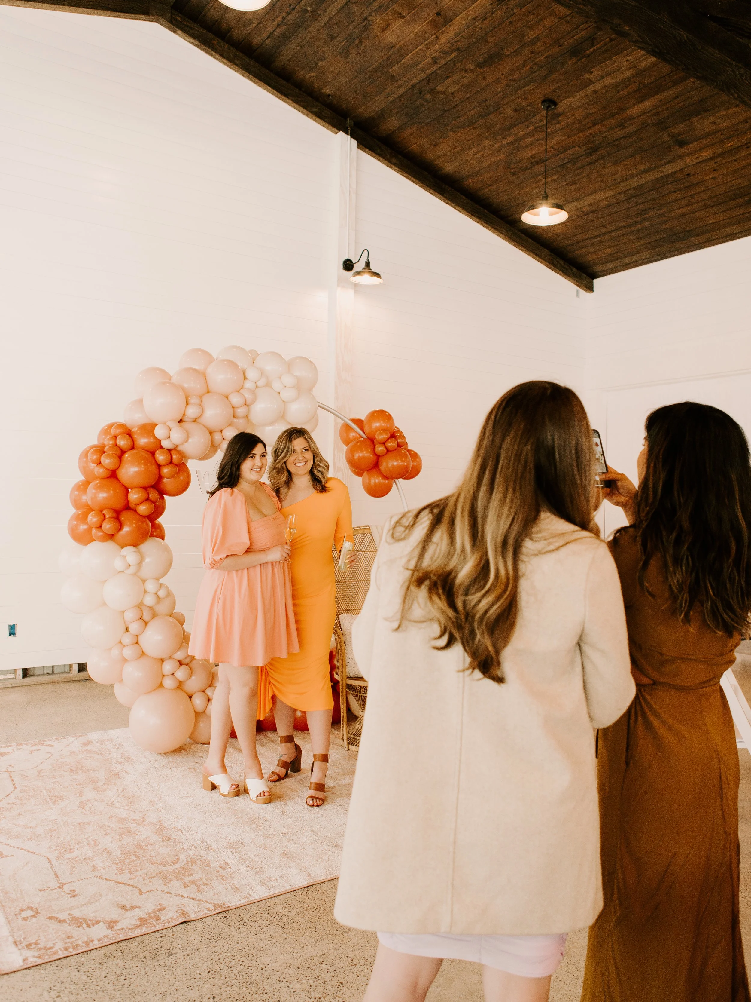 bridal-shower-balloon-backdrop-orange-neutrals-boho-happy-guests.JPG