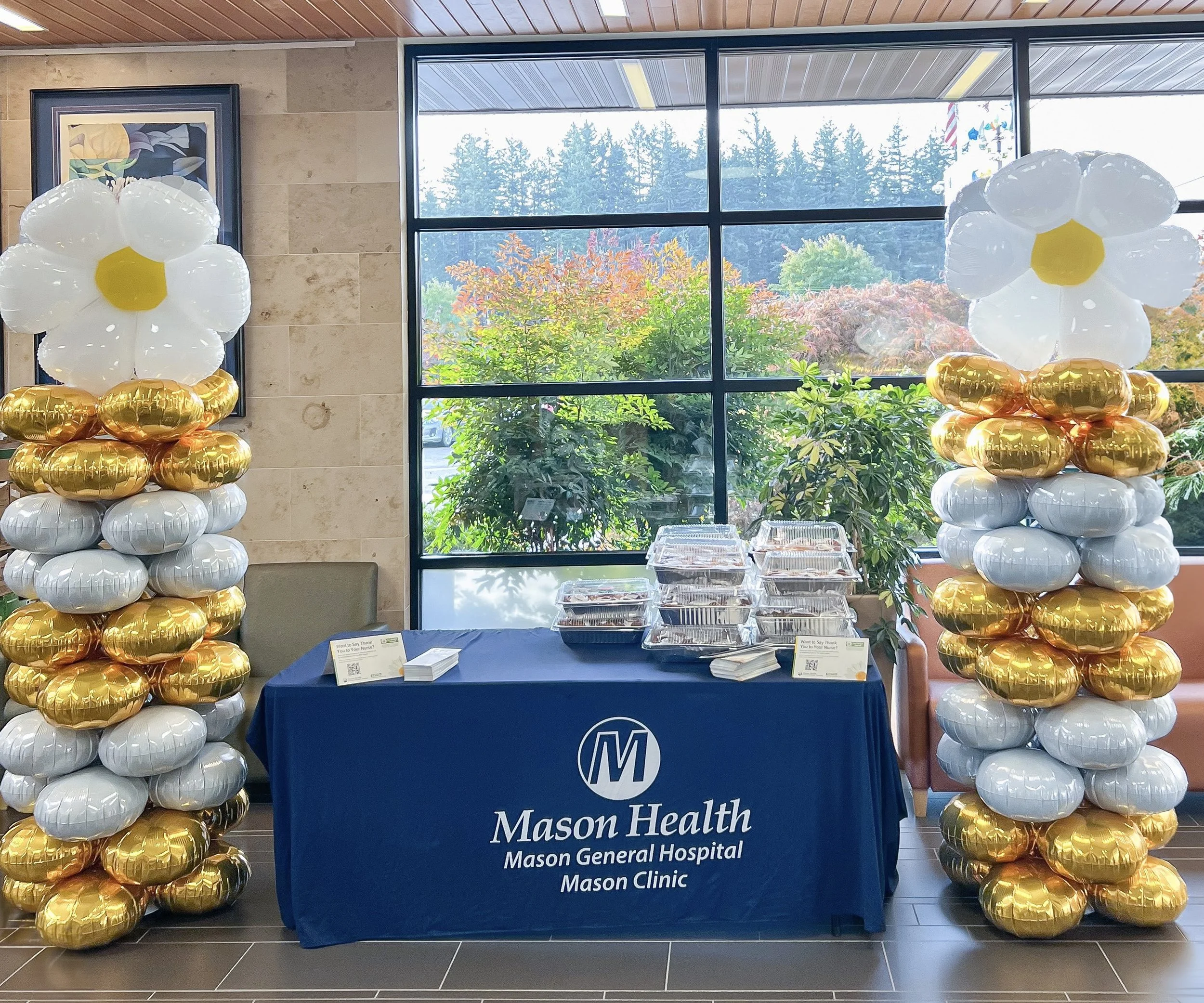 Mason-health-business-event-table-pillars-daisies-mylar.JPEG