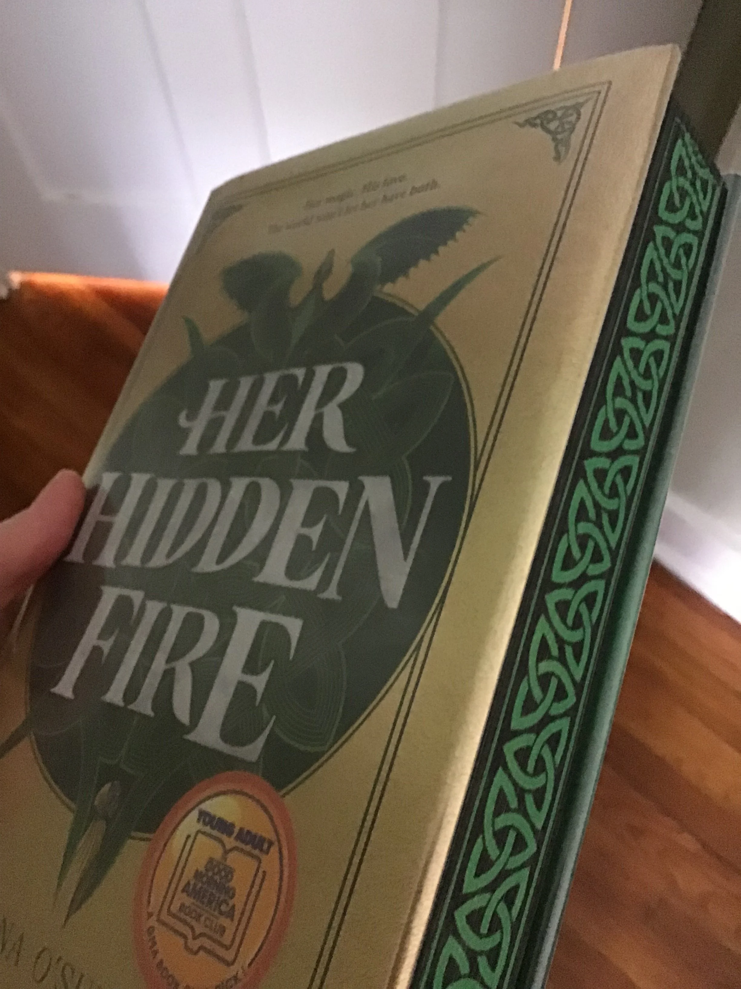 Her Hidden Fire with page edges dyed with a green and black Celtic pattern