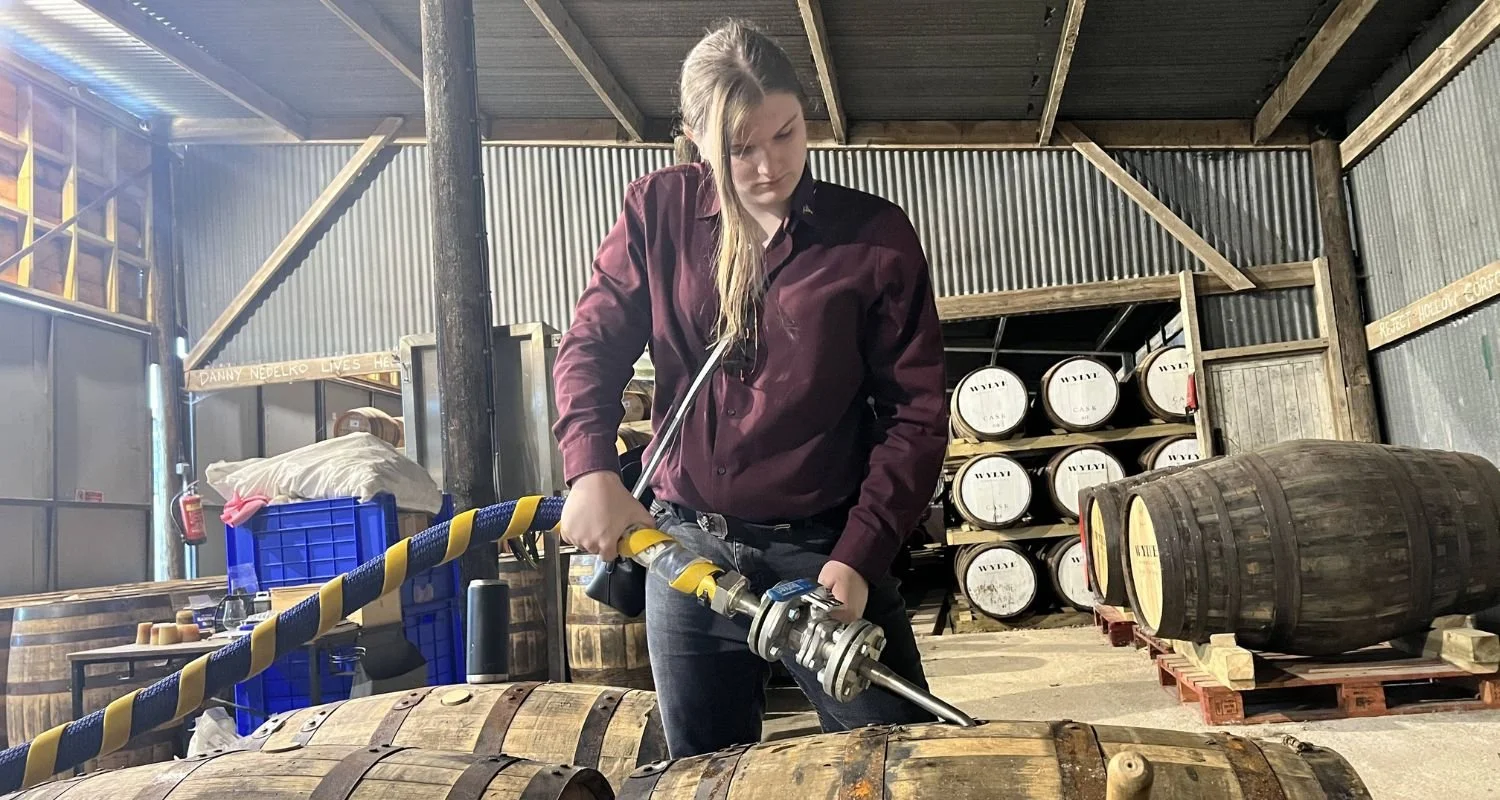 Jade Cox filling a whisky barrel
