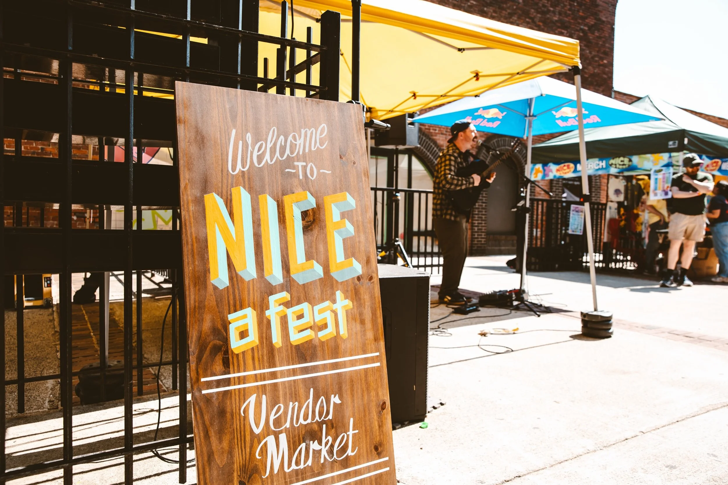 Still thinking about the NICE, a fest x @smallmartmarket vendor markets we had this summer! 🙂☀️ thanks to all the NICE vendors are performers! 

Pictured @fallrisk alongside out hand painted sign from @slowburnsigns 📸 by @rosequeenphoto

@wildplane