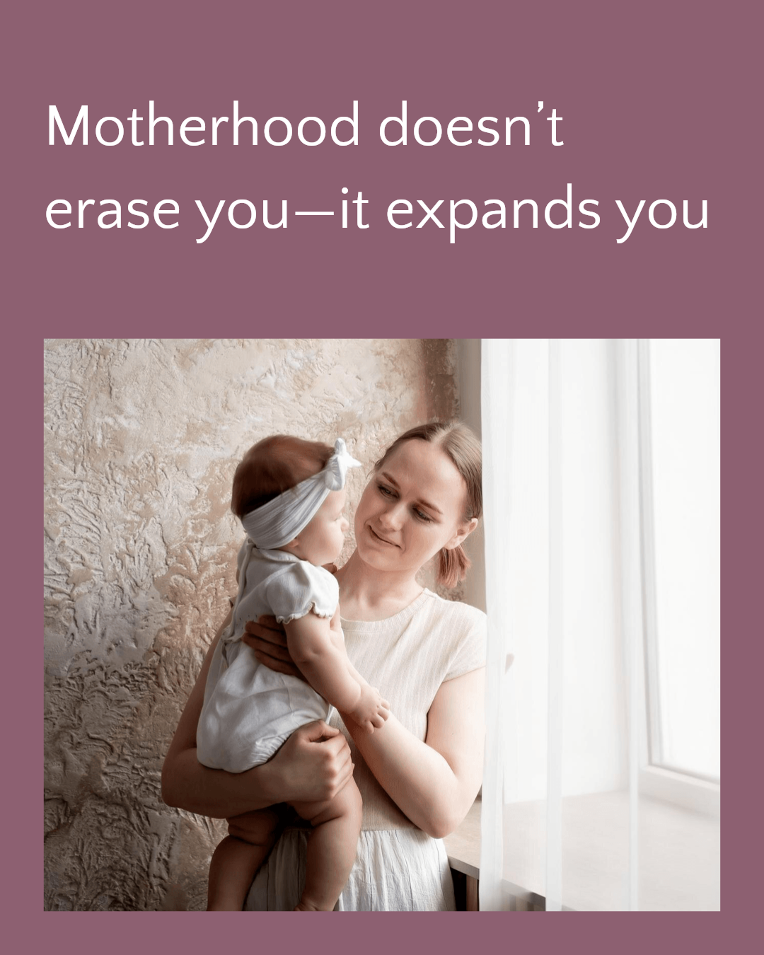 A woman holding a baby girl near a window with white curtains
