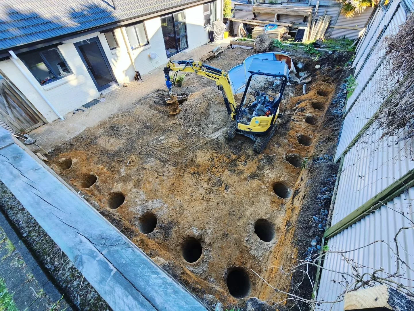 50m3 out through the back fence, creating a single level backyard ready for retaining and a new pool.