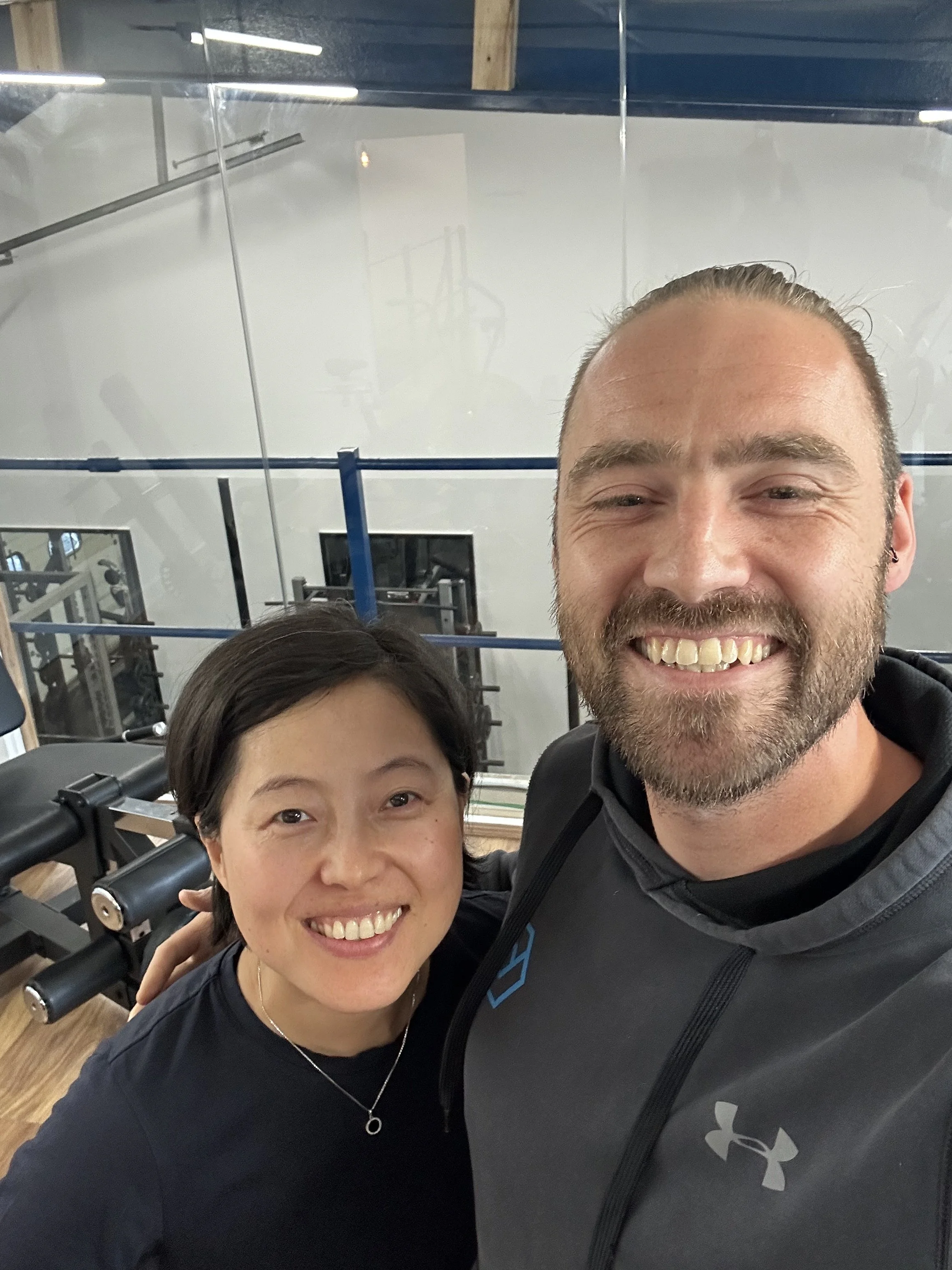 Jamie, owner of JJ Strength, with one of his clients at his personal training gym in oxford