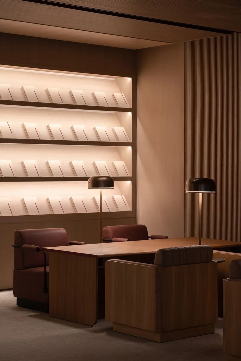 An interior shot of the design studio, featured wooden panelled walling with ambient lighting and meeting areas.