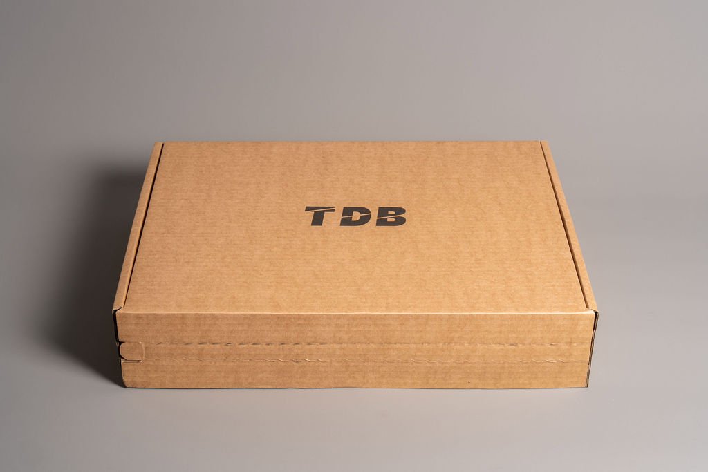 TheDesignerBox apparel packaging corrugated box and glassine bag