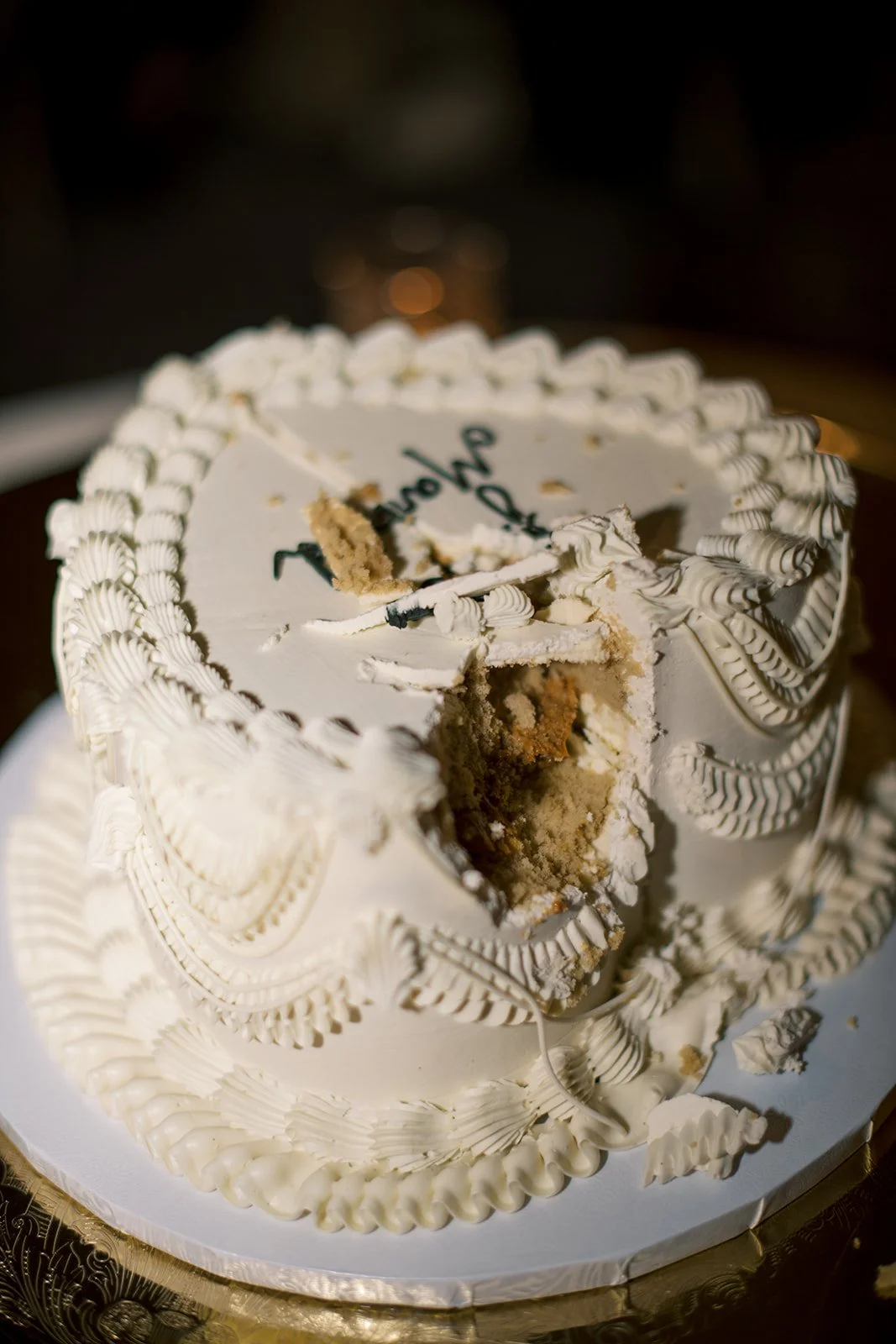 close up of the small heart shaped wedding cake with the first cut made
