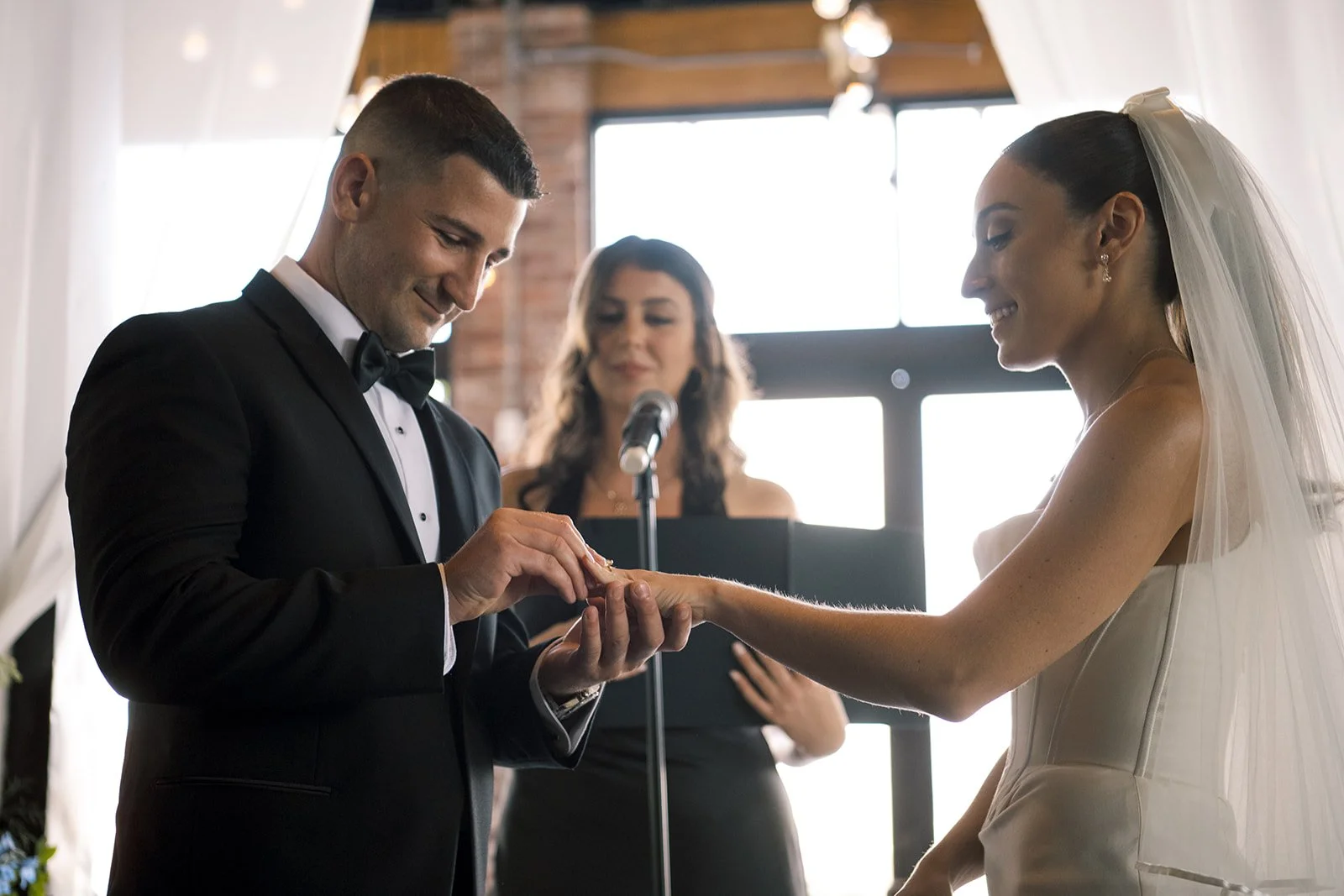 groom places wedding ring on the bride. Battello Wedding