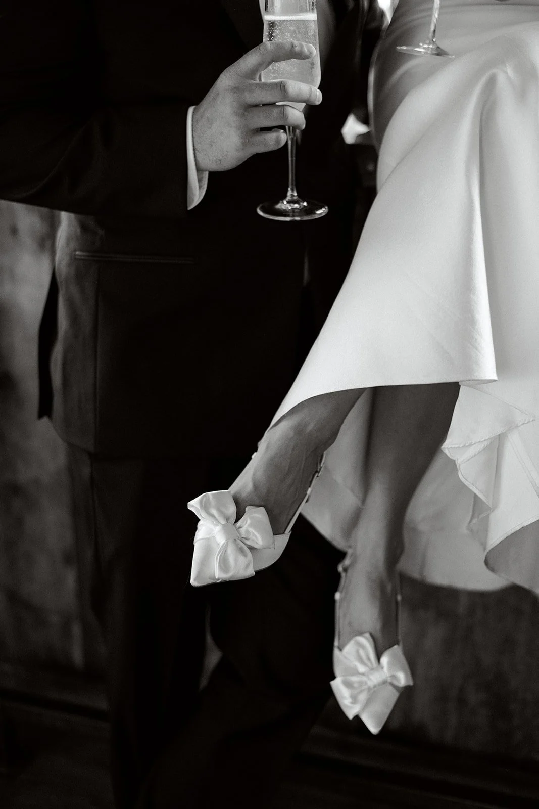detail photo of bride's white shoes with bows