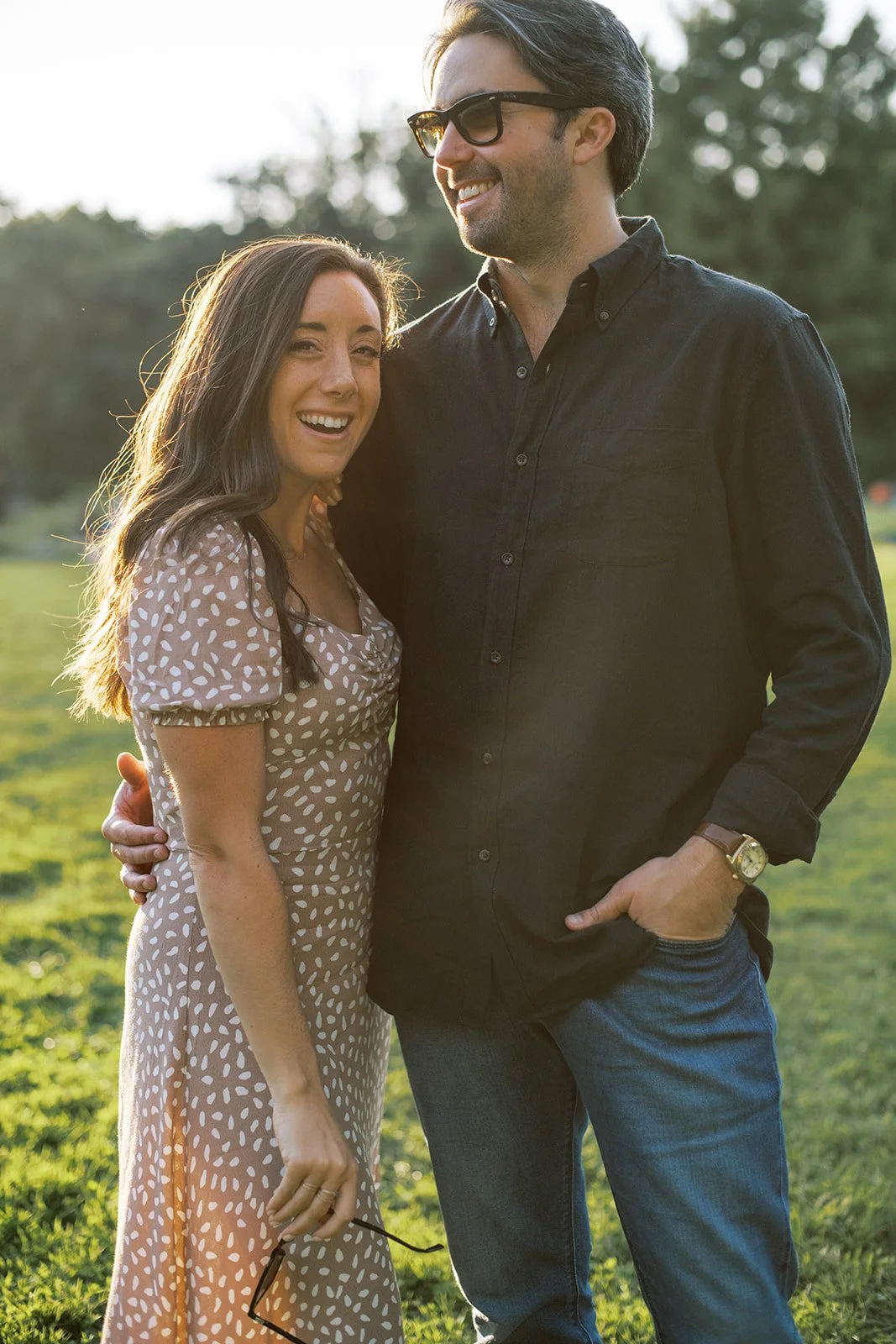 Couple laughing together during golden hour in a park