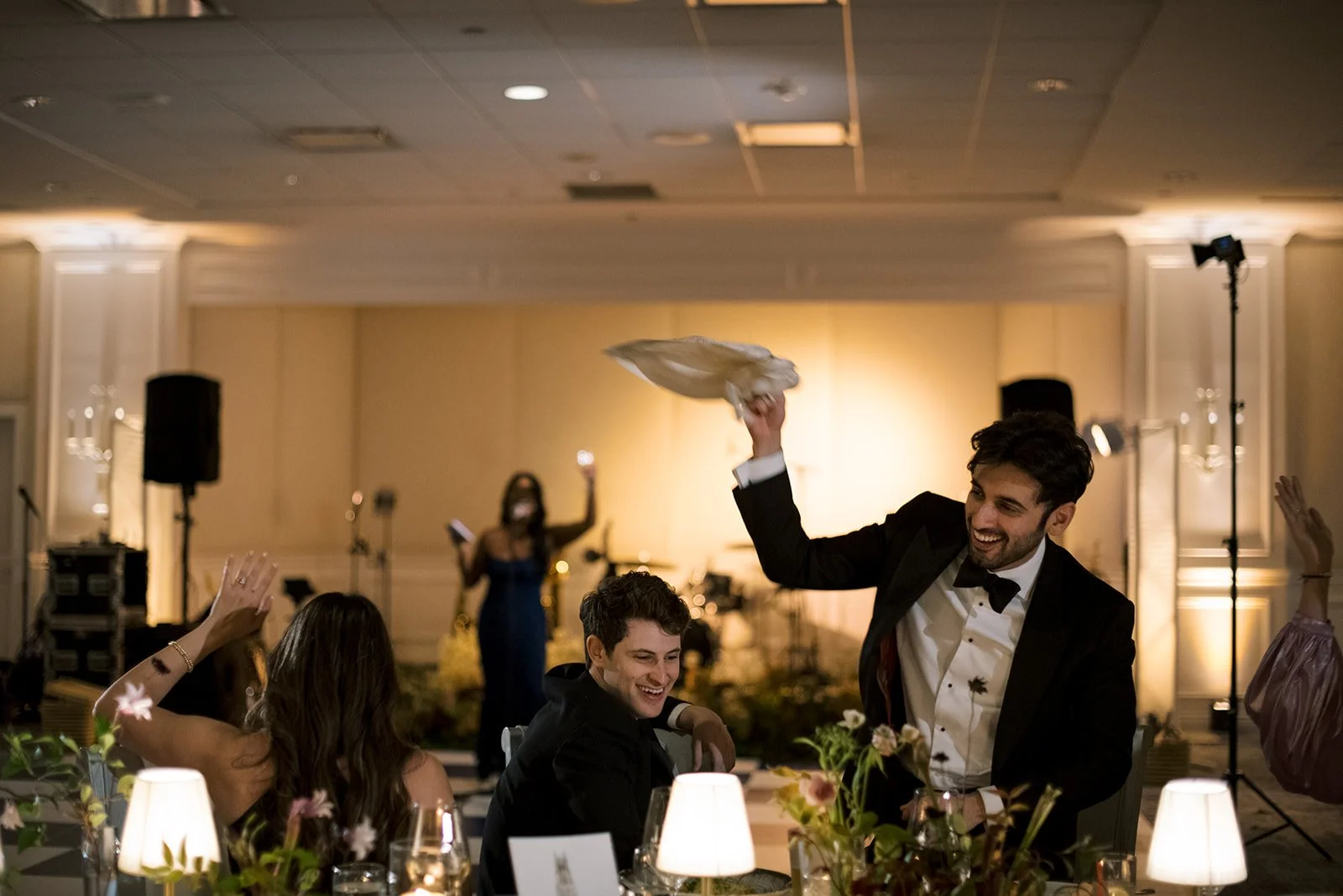 black tiewedding guest waving napkins in the air