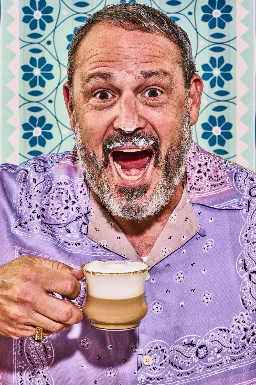 Portrait of Mike drinking cappuccino with foam on nose