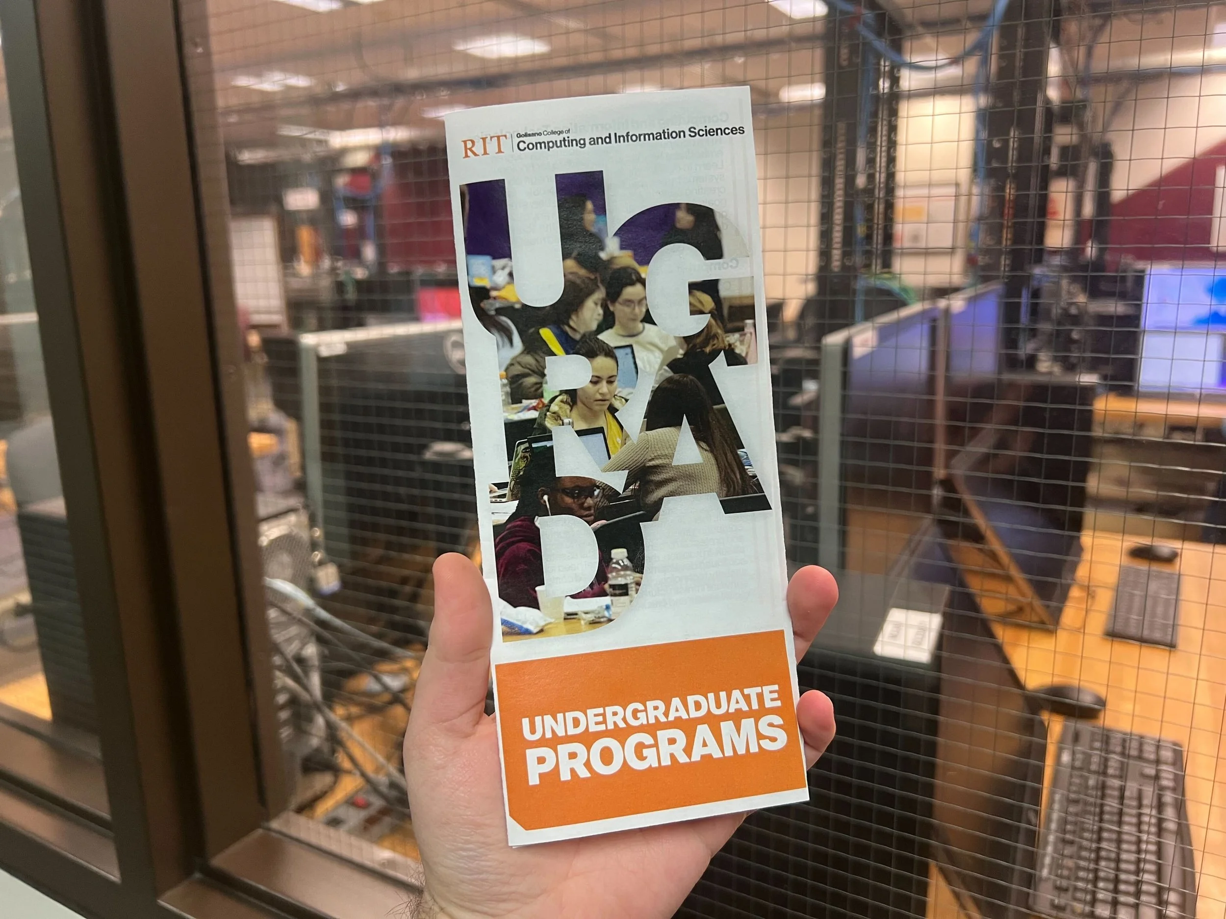 Printed Ugrad brochure in front of computing lab