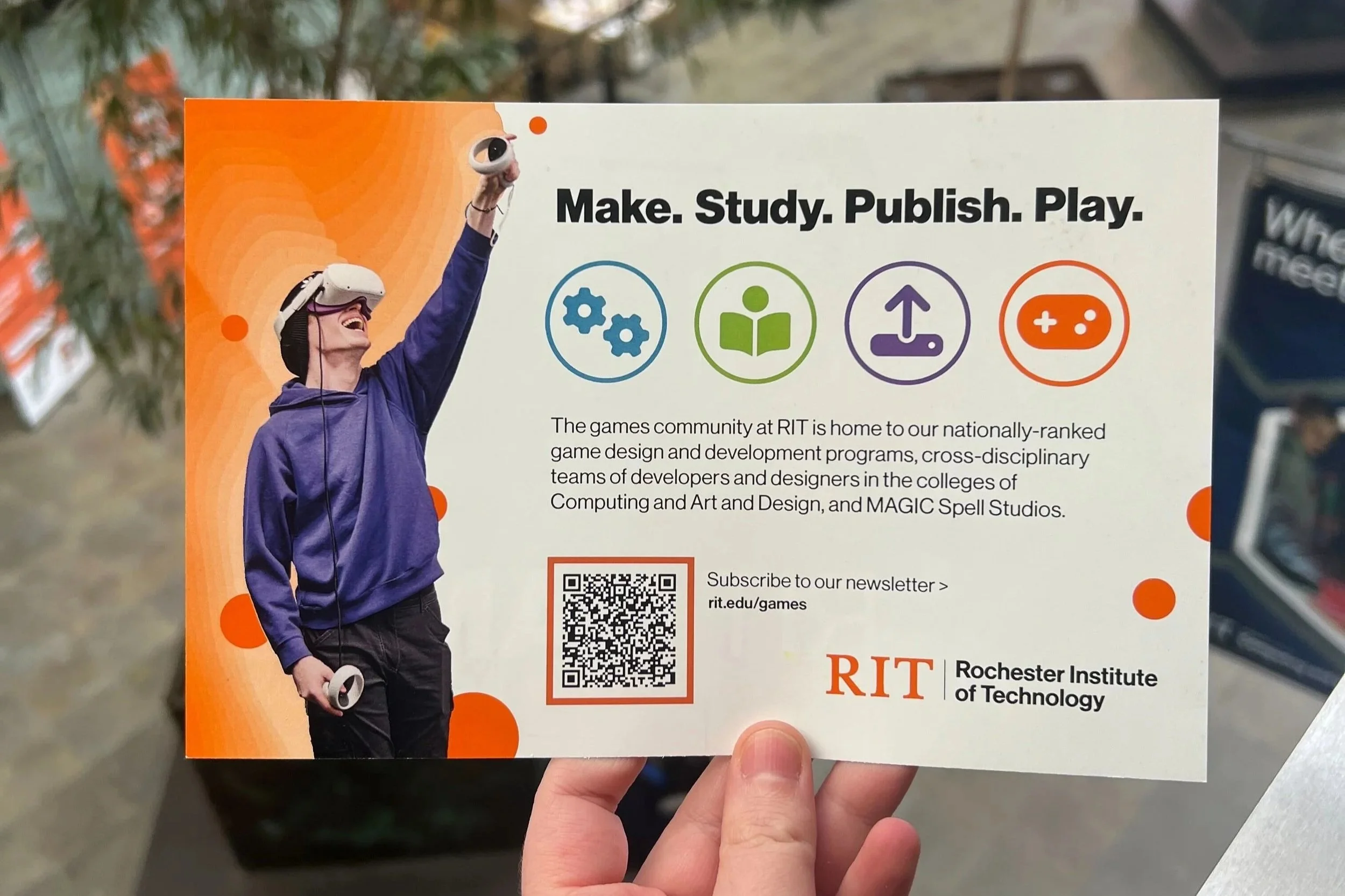 RIT GAMES postcard - back picturing a student in a VR headset next to information about RIT games programs