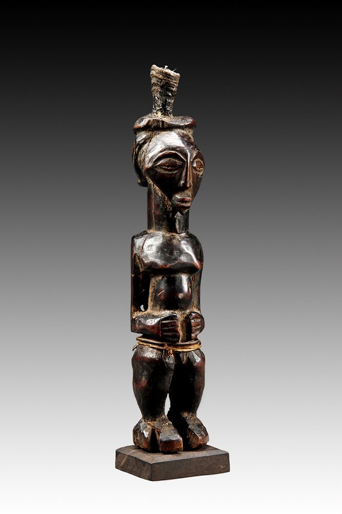 Songye figure with arms bent and hands resting on abdomen.  www.gallerytribalart.com