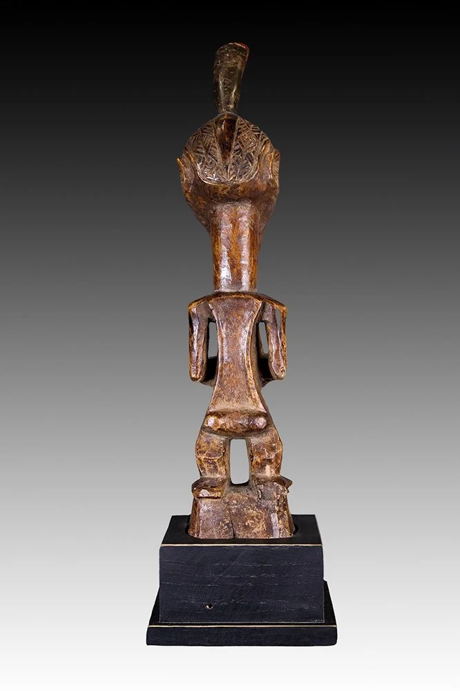 Songye fetish figure with feet on base.  www.gallerytribalart.com