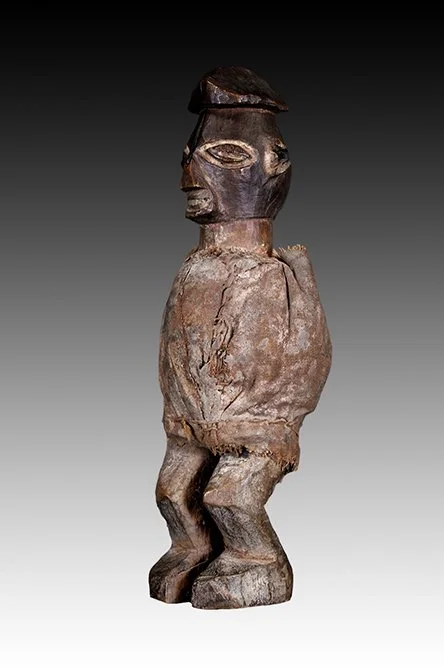 Yaka wood carved figure covered by fiber cloth with tukula powder.  www.gallerytribalart.com