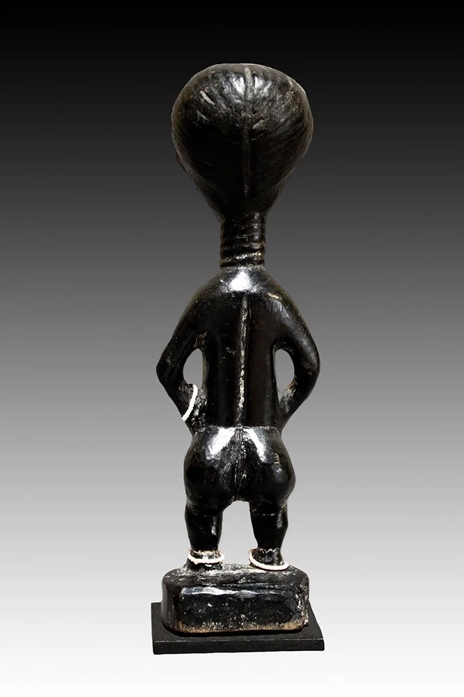 Akan figure with hands to abdomen and feet on base.  www.gallerytribalart.com