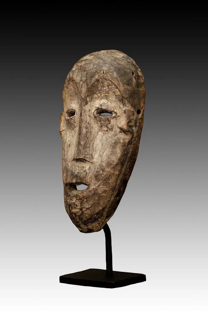 Lega mask has kaolin pigment and a light brown patina.  www.gallerytribalart.com