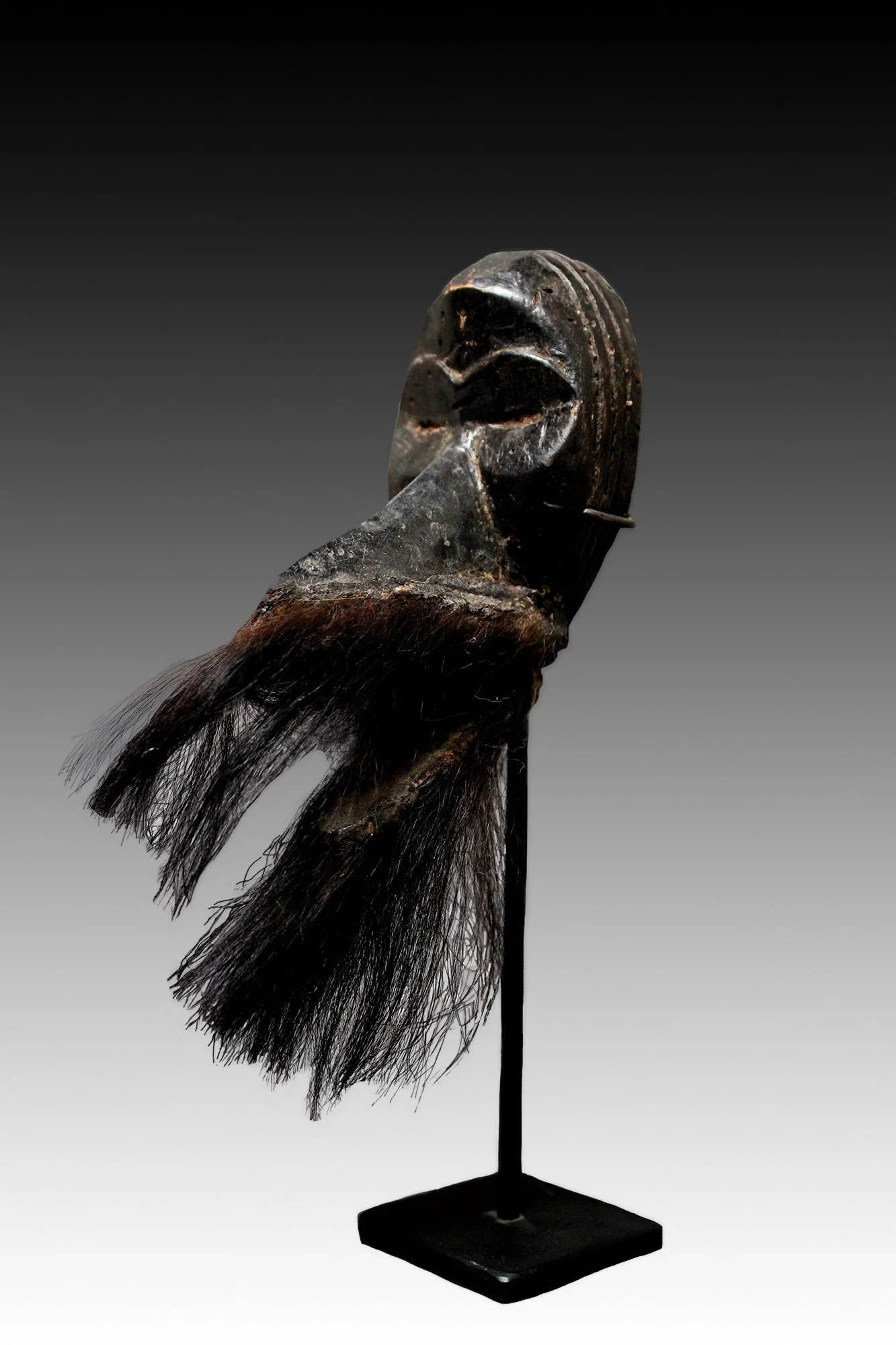 Dan Gagon mask, this miniature mask has slit eyes, a large beak or snout, the lower jaw is moveable.  www.gallerytribalart.com