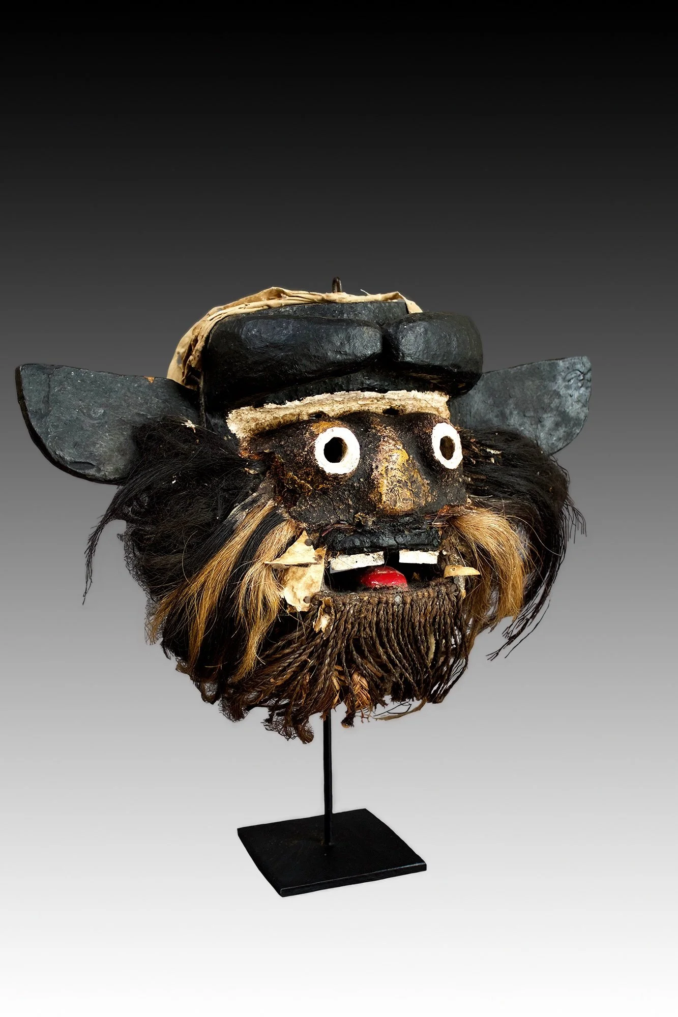 Guere mask has painted tubular eyes, horns on the forehead, open mouth with teeth.  www.gallerytribalart.com