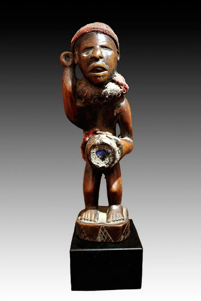 Kongo figure has a glass abdomen with magical materials.  www.gallerytribalart.com