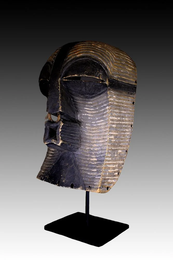 Songye Kifwebe mask with half moon eyes, large jutting mouth and flat crest.  www.gallerytribalart.com