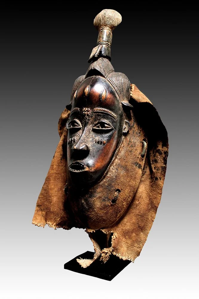 Guro mask with wooden collar, fabric from costume and verses of Koran in leather pouch.  www.gallerytribalart.com