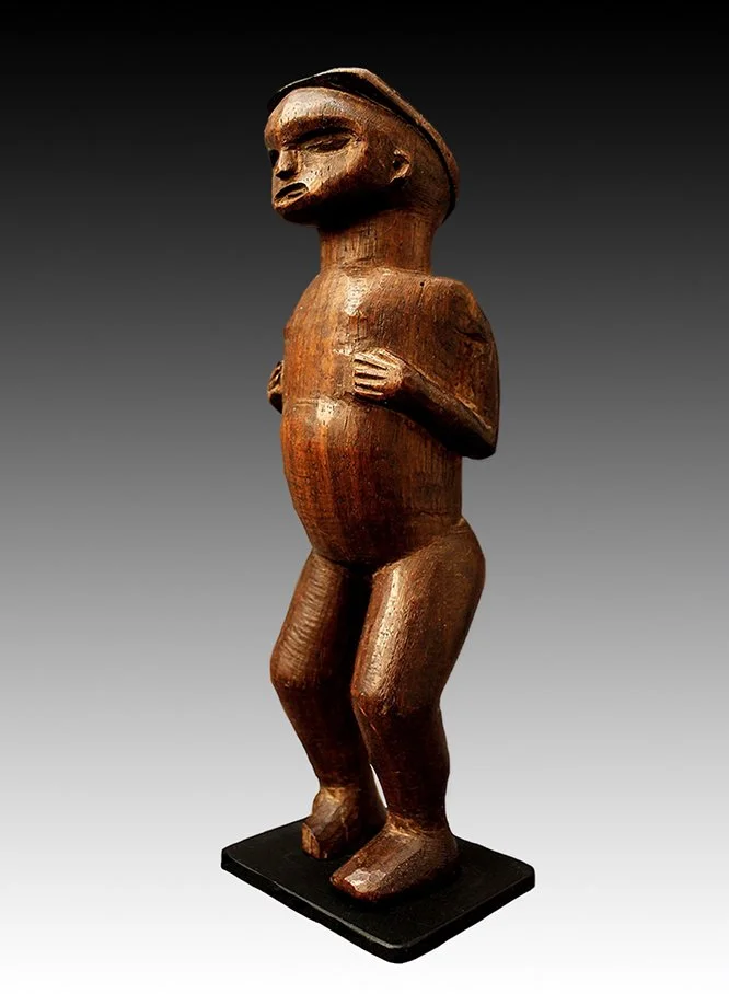 Chokwe wood carved statue with protruding torso.  www.gallerytribalart.com