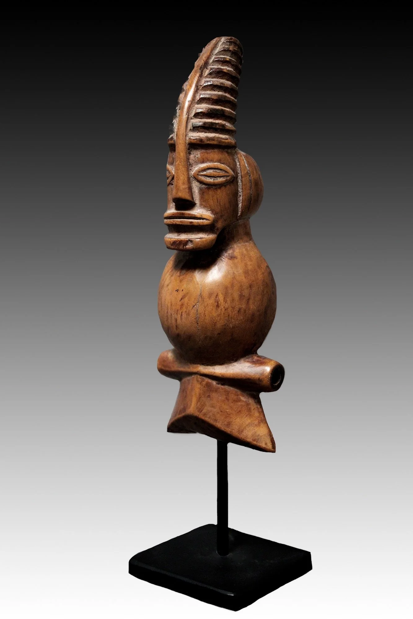 Chokwe whistle whistle is decorated with a Cikunza headdress associated with the Mukanda circumcision ritual.  www.gallerytribalart.com