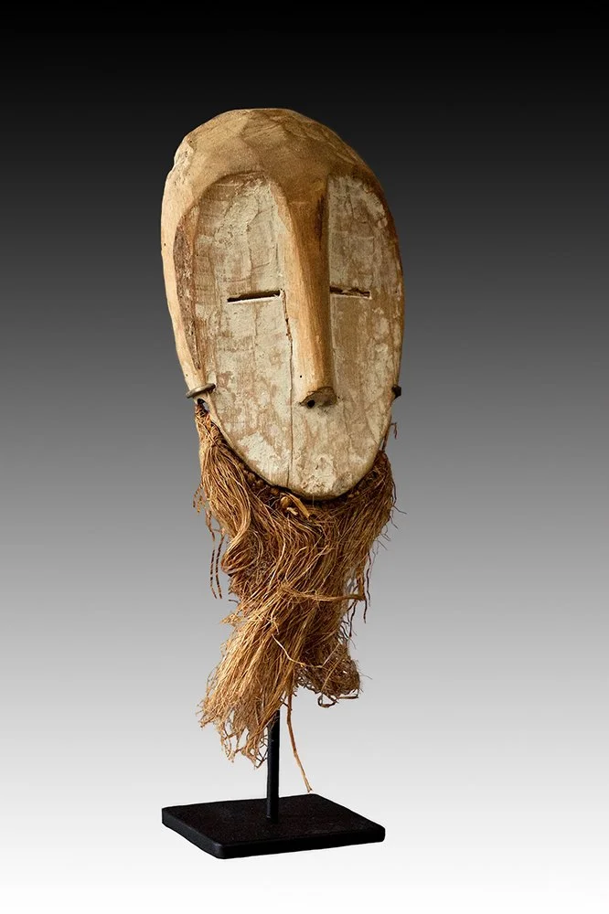Lega mask has light brown patina and kaolin pigment.  www.gallerytribalart.com